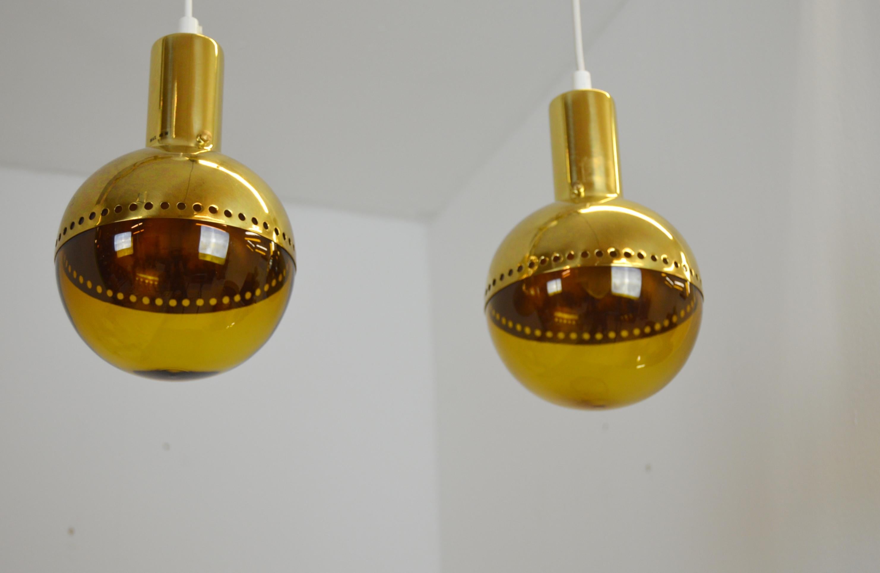 A set of two exclusive Patricia ceiling or window lamps designed and manufactured by Hans Agne Jakobsson in Markaryd, Sweden. 

Amber colored glass and brass. The height below is stated without the electrical cord.