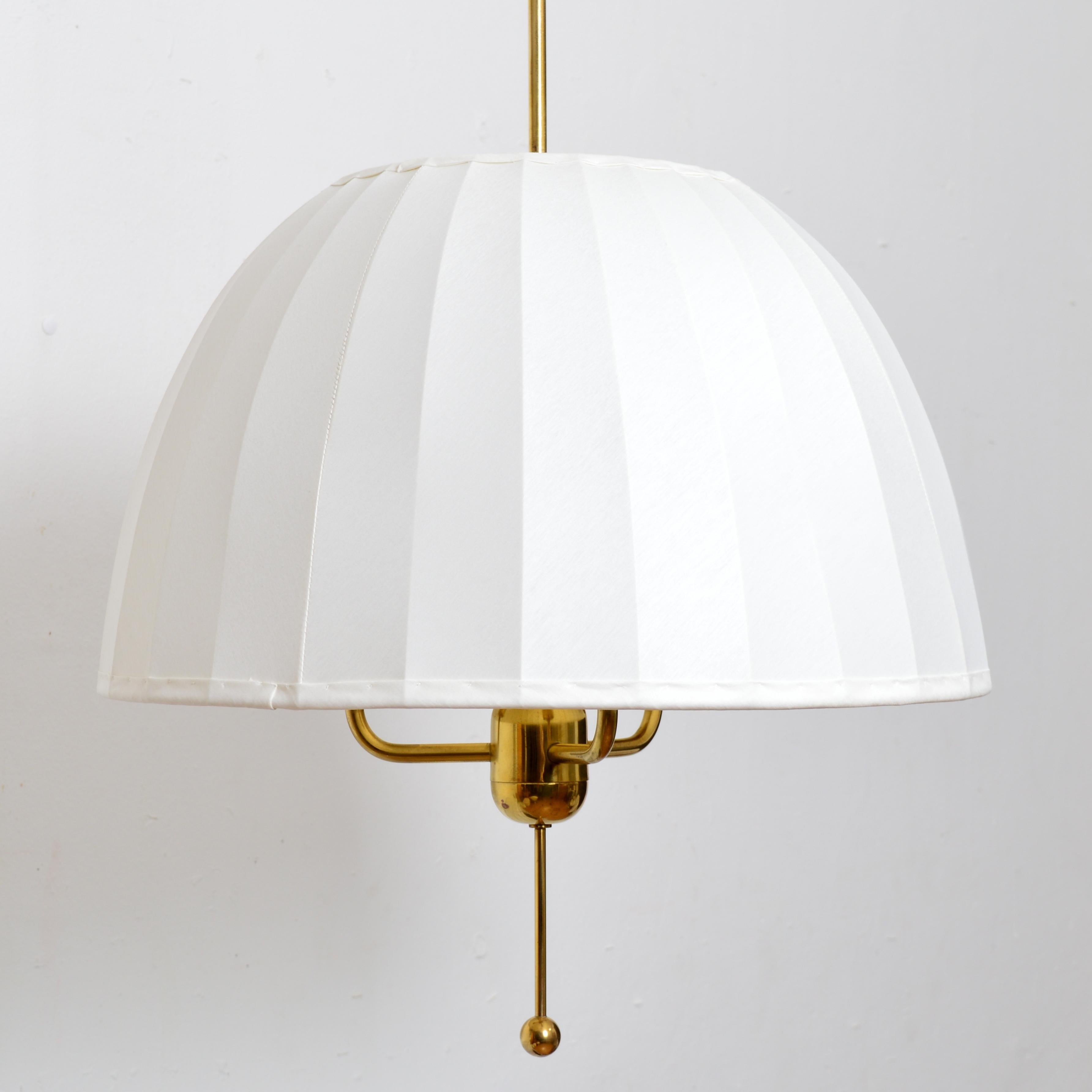 Merveilleuse lampe suspendue 'Caroline' modèle T549/3 conçue en 1963 par Hans-Agne Jakobsson pour sa propre entreprise à Markaryd, Suède. Une monture en laiton avec un abat-jour original redressé en tissu chintz blanc cassé.  Excellent état vintage.