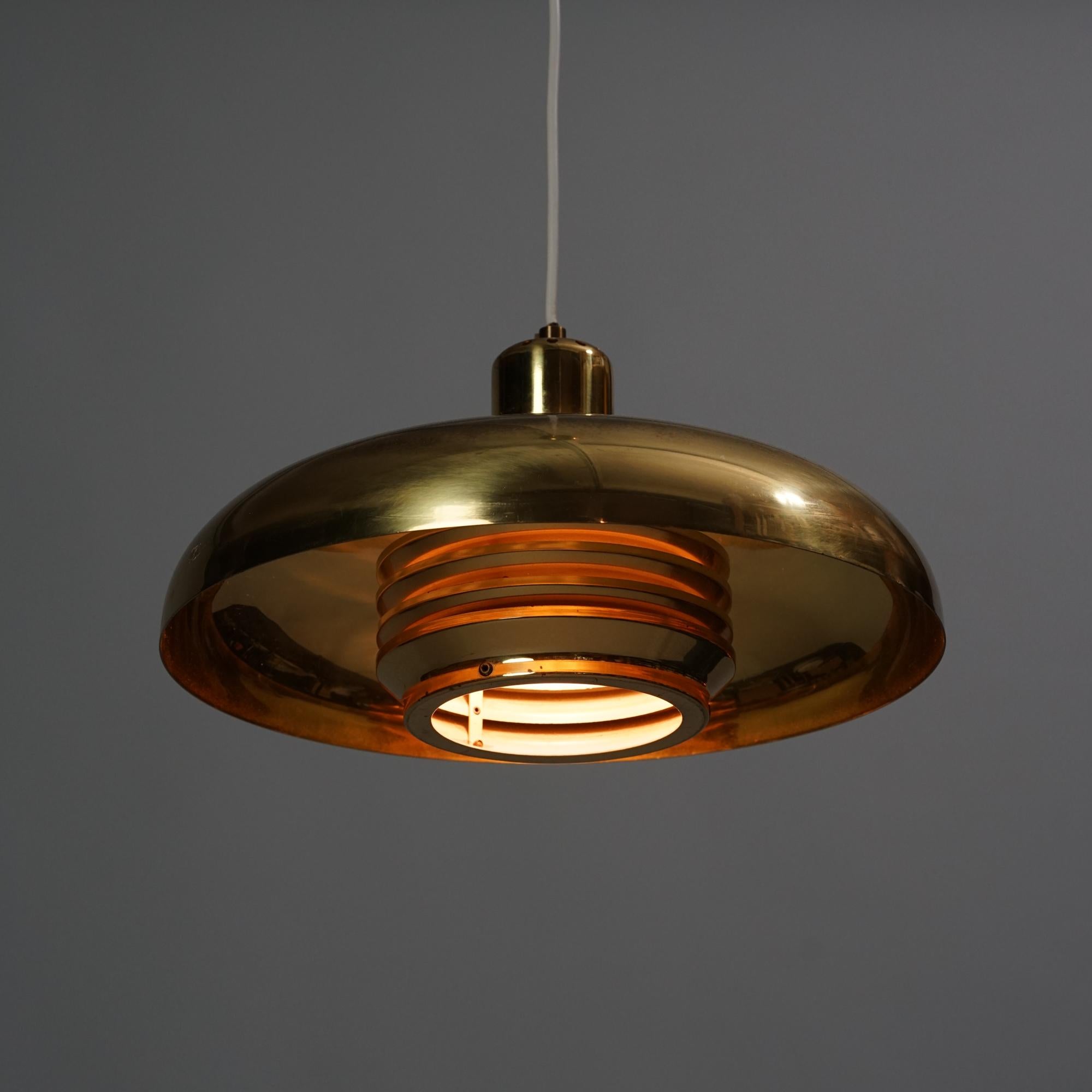 Hans-Agne Jakobsson pendant model T-792 for AB Markaryd from the 1960s. Brass. Good vintage condition, minor patina and wear consistent with age and use. Classic Scandinavian Modern design.

Hans-Agne Jakobsson (1919-2009) was a Swedish furniture