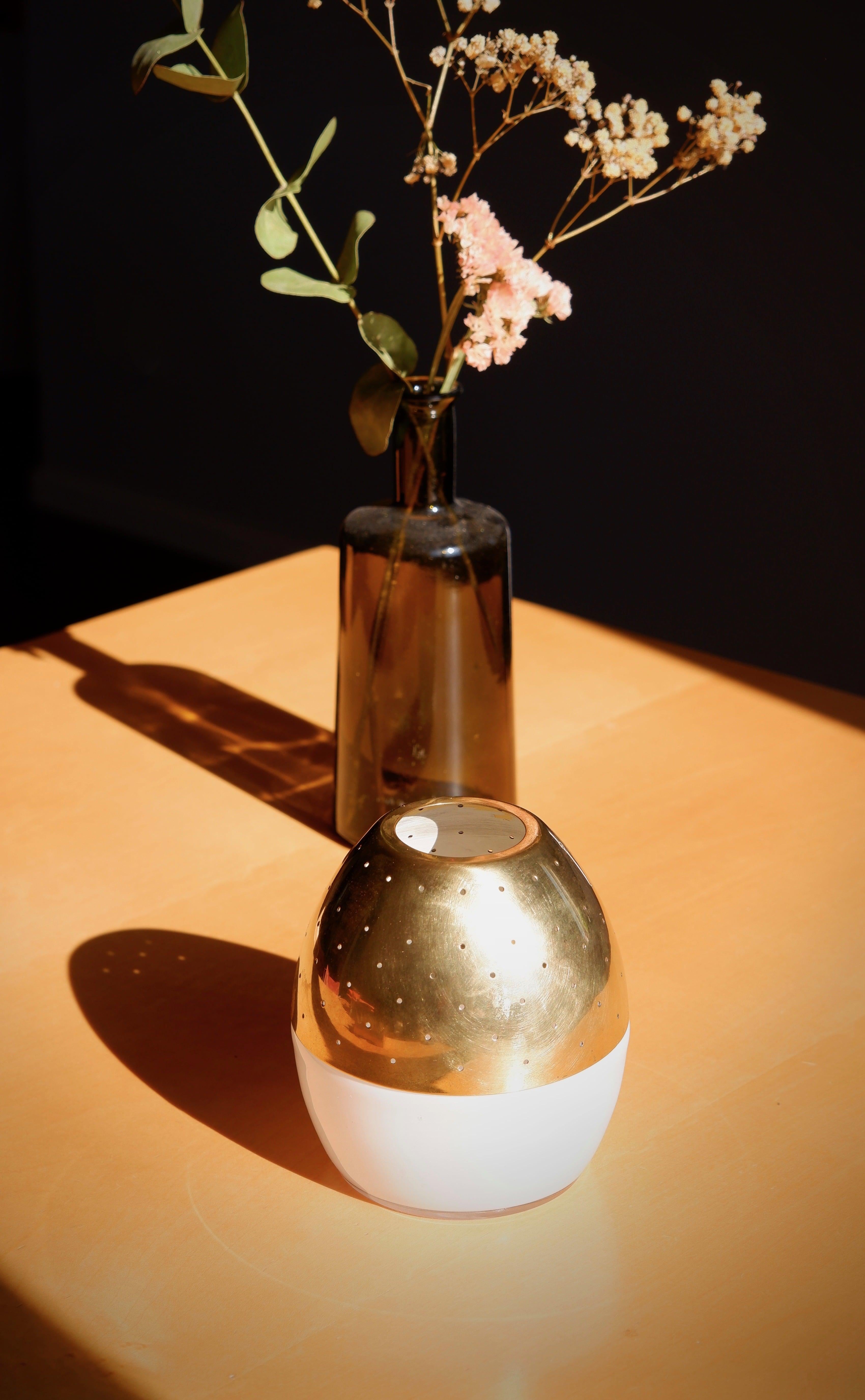 Rare and special candle lamp design by Hans agne Jakobsson in the 60's and produced in his own factory in Markaryd sweden during that same time. The candel lamp is made with a opal glass base that let the light reflect on it. It has a brass