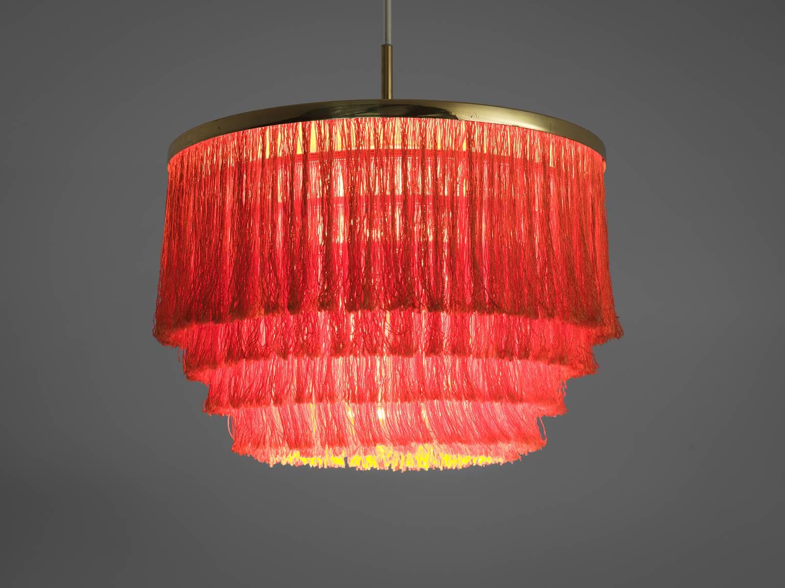 Hans-Agne Jakobsson, chandelier, brass, red silk string, Sweden, 1970s.

This voluptuous chandelier holds a brass frame. The frame has one stem of which rich, layered silk flows. As a result of this material, the light partition is very warm as
