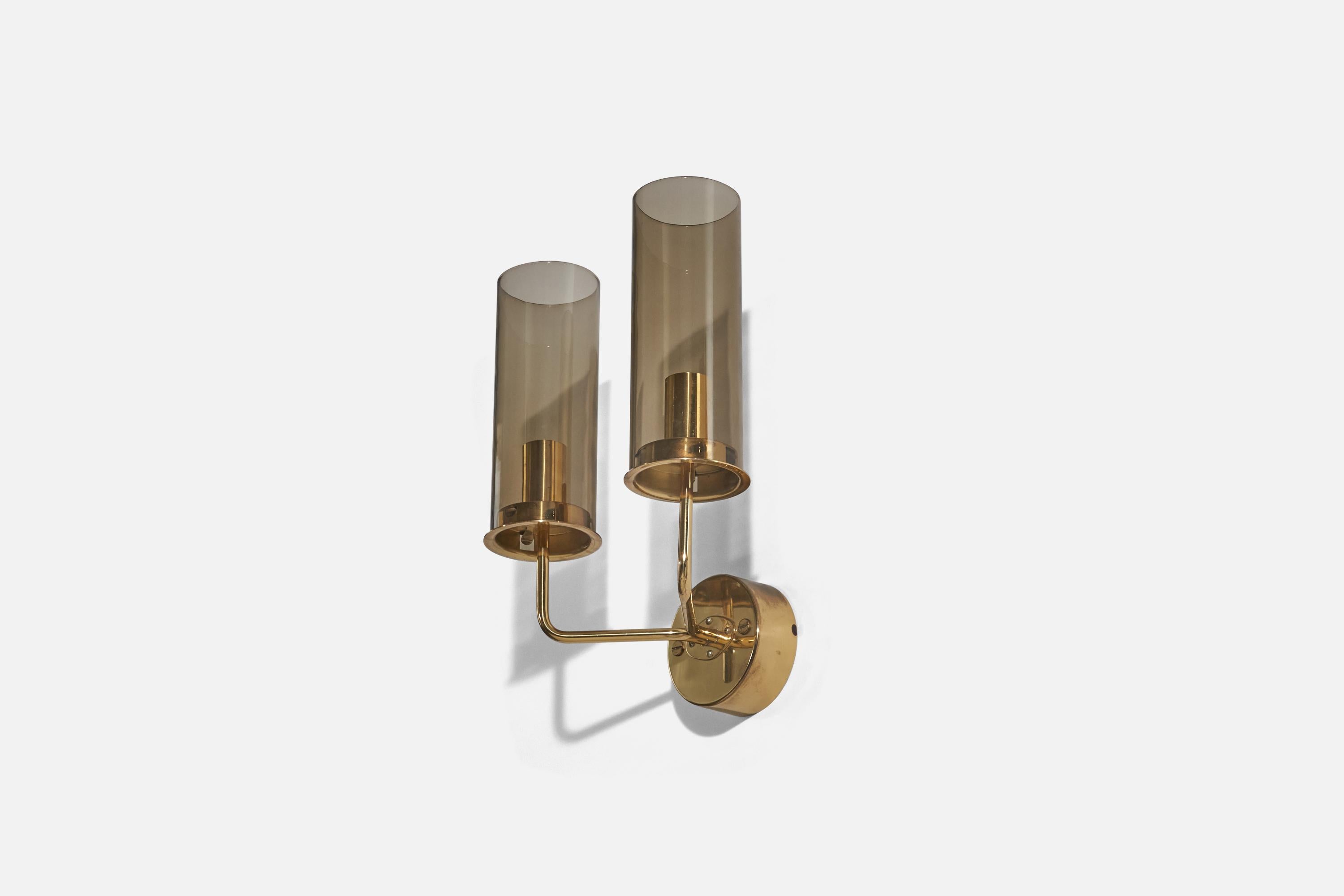 A brass and glass sconce/ wall light designed by Hans-Agne Jakobsson and produced by his own firm in Markaryd, Sweden. c. 1970s.

Dimensions of back plate (inches) : 4.07 x 4.07 x 1.60 (height x width x depth).

Socket takes E-14 bulb. 
The