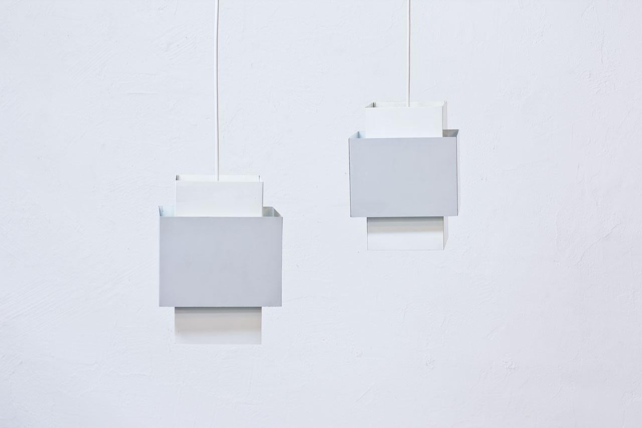 Pair of pendant lamps model T 174 “Selectra” designed by Hans-Agne Jakobsson for his own company at Markaryd in Sweden during the 1960s. Lacquered metal sheets in grey and
white. New electricity. Labeled.