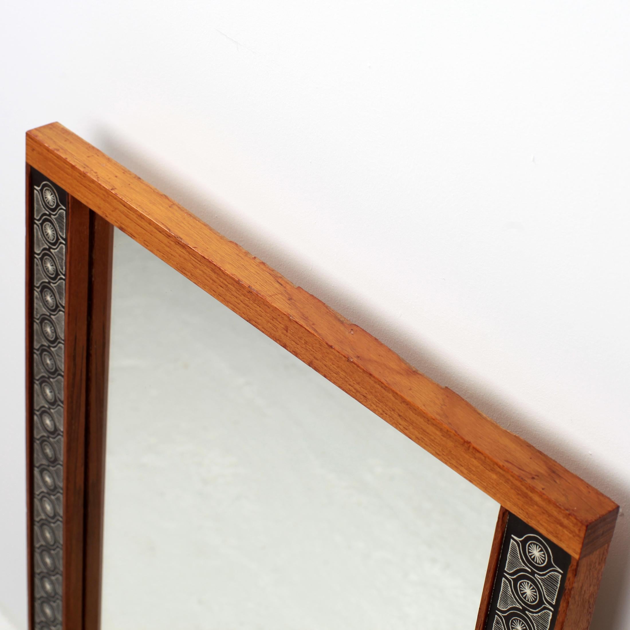 Rare and beautiful mirror by Hans-Agne Jakobsson for Markaryd in Ahus Sweden, circa 1950.
The frame is in solid teak with black and white paper decor.
Beautiful patina.
Stamp on the back.