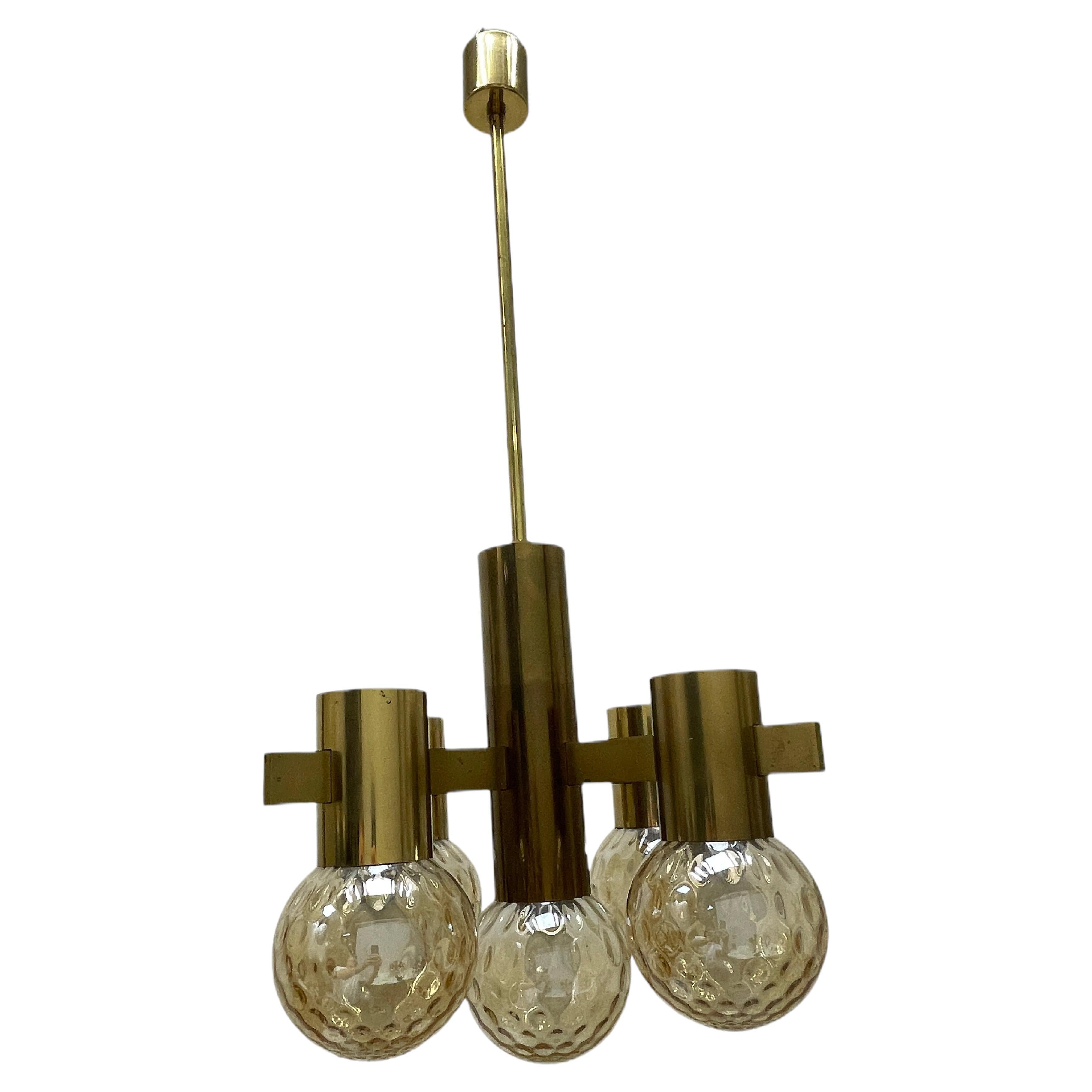 Very decorative and beautiful chandelier made of brass, fitted with five E14 sockets with glass ball shades. Made by Hans Agne Jakobsseon in the 1960s. The fixture requires five European E14 / 110 Volt bulbs, each bulb up to 40 watts. The brass has