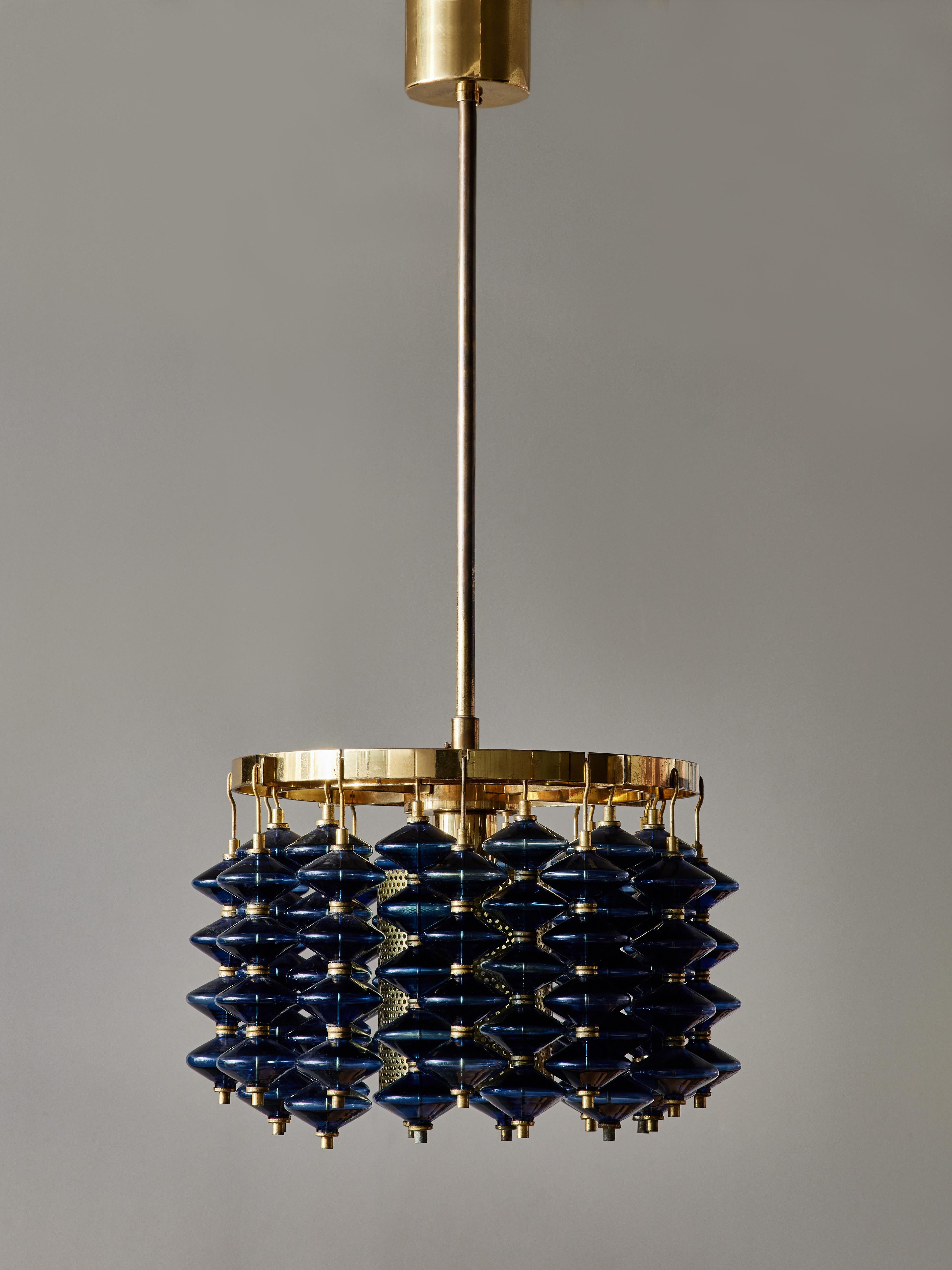 Beautiful Scandinavian chandelier designed by Hans-Agne Jakobsson for his own firm. Brass circular frame and inner cylinder, blue glass prismas mounted on twenty-four hanging brass strands in two rows on the frame. Usually found in clear or amber,