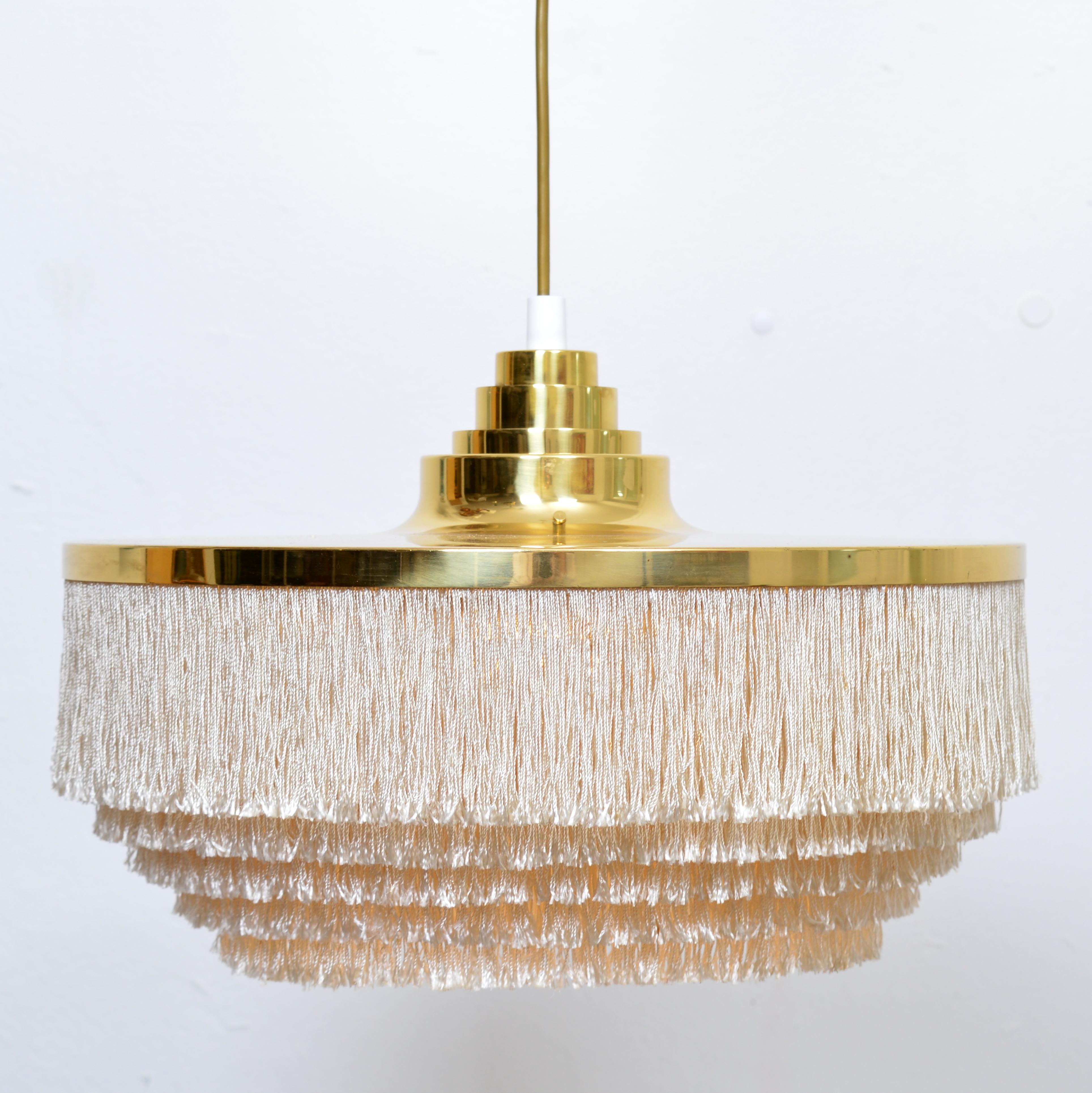 A fringed pendant light by the Swedish designer Hans-Agne Jakobsson for his own company in Markaryd, Sweden, mid-20th century. A very nice piece of Scandinavian modern design. The fixture comprises a large brass shade with stepped detail, and five