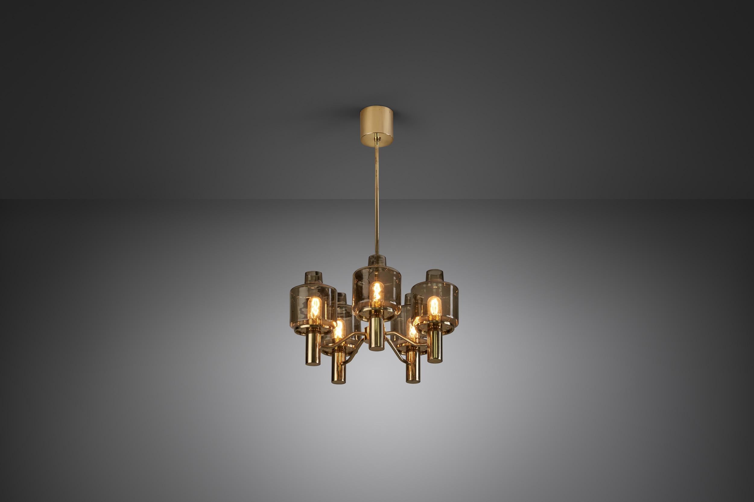 This marvellous, brass five-light chandelier was created in what we now call “the golden age of Scandinavian design”. Hans-Agne Jakobsson was the great Swedish master of lighting, designing some of the most recognizable mid-century modern lamps of