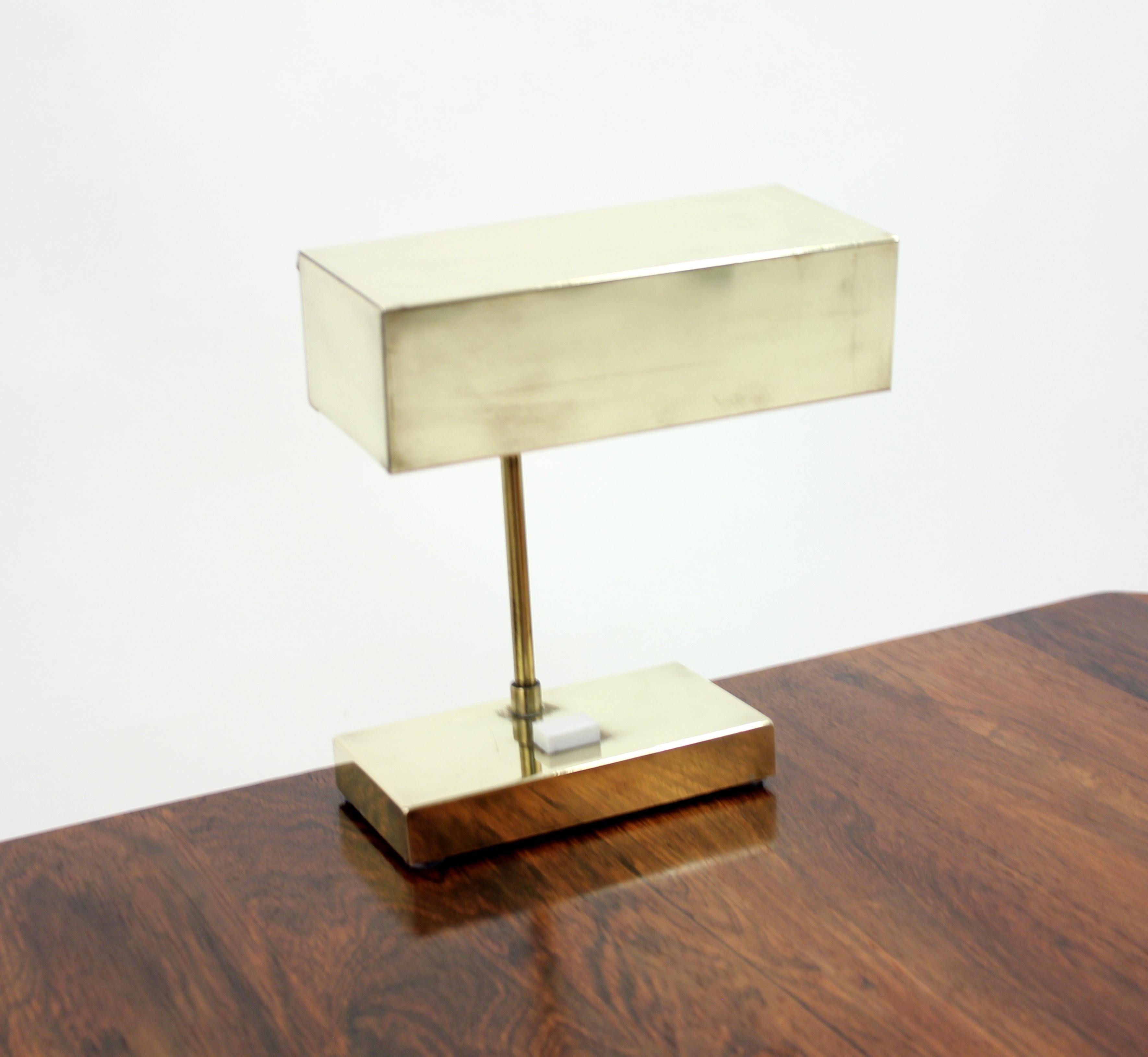 Model 2201 brass table lamp by Hans-Agne Jakobsson for Elidus. Marked by the maker under the foot. Adjustable shade that can be moved up and down. Original white plastic screen under the shade. Very good vintage condition with a small damage on one