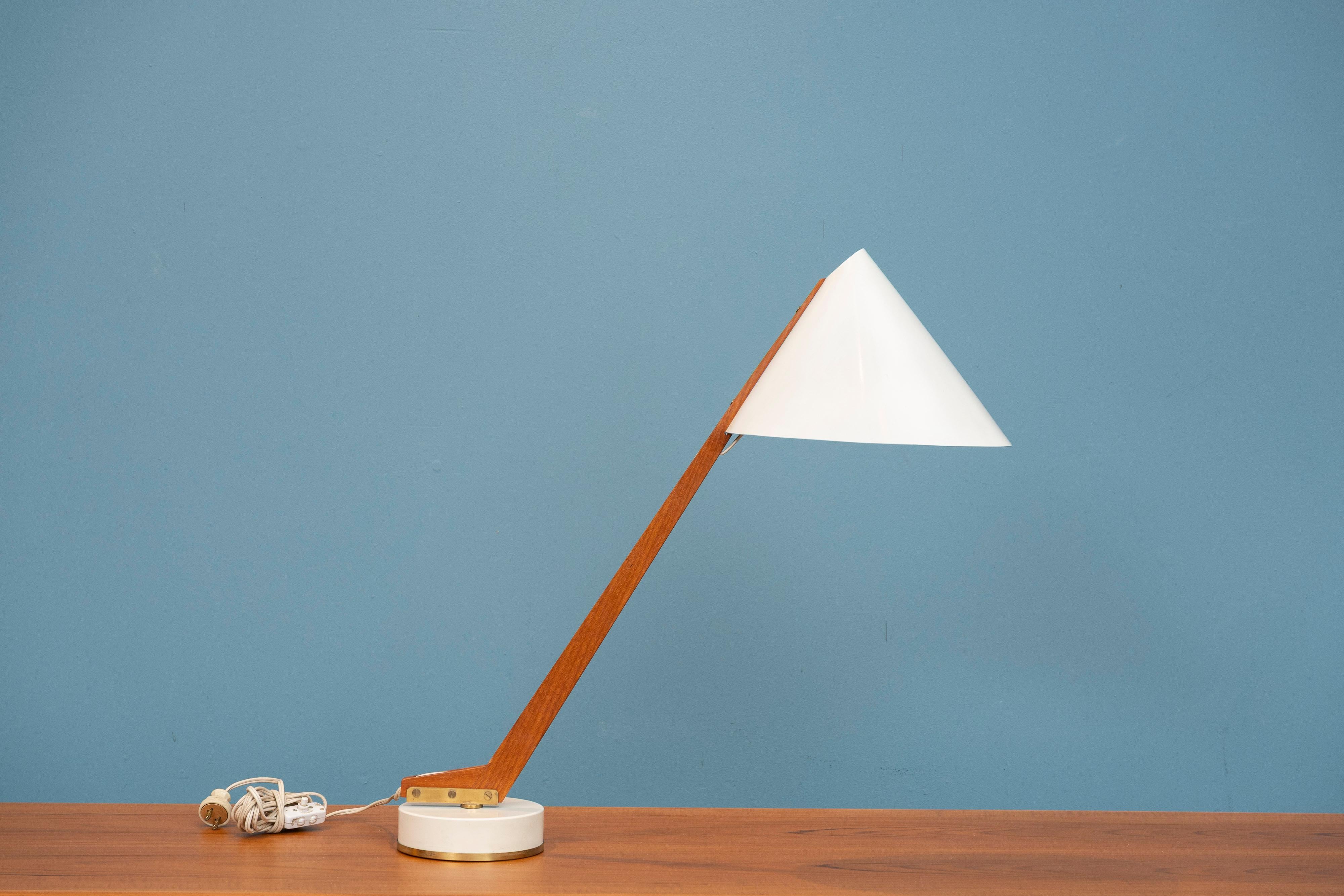 Hans-Agne Jakobson design table or task lamp, Model B-54 for AB Markaryd. Elegant task lamp that swivels 360 degree to desired position. Enameled metal shade and base with a teak angular arm and brass fittings. In very good original condition, ready