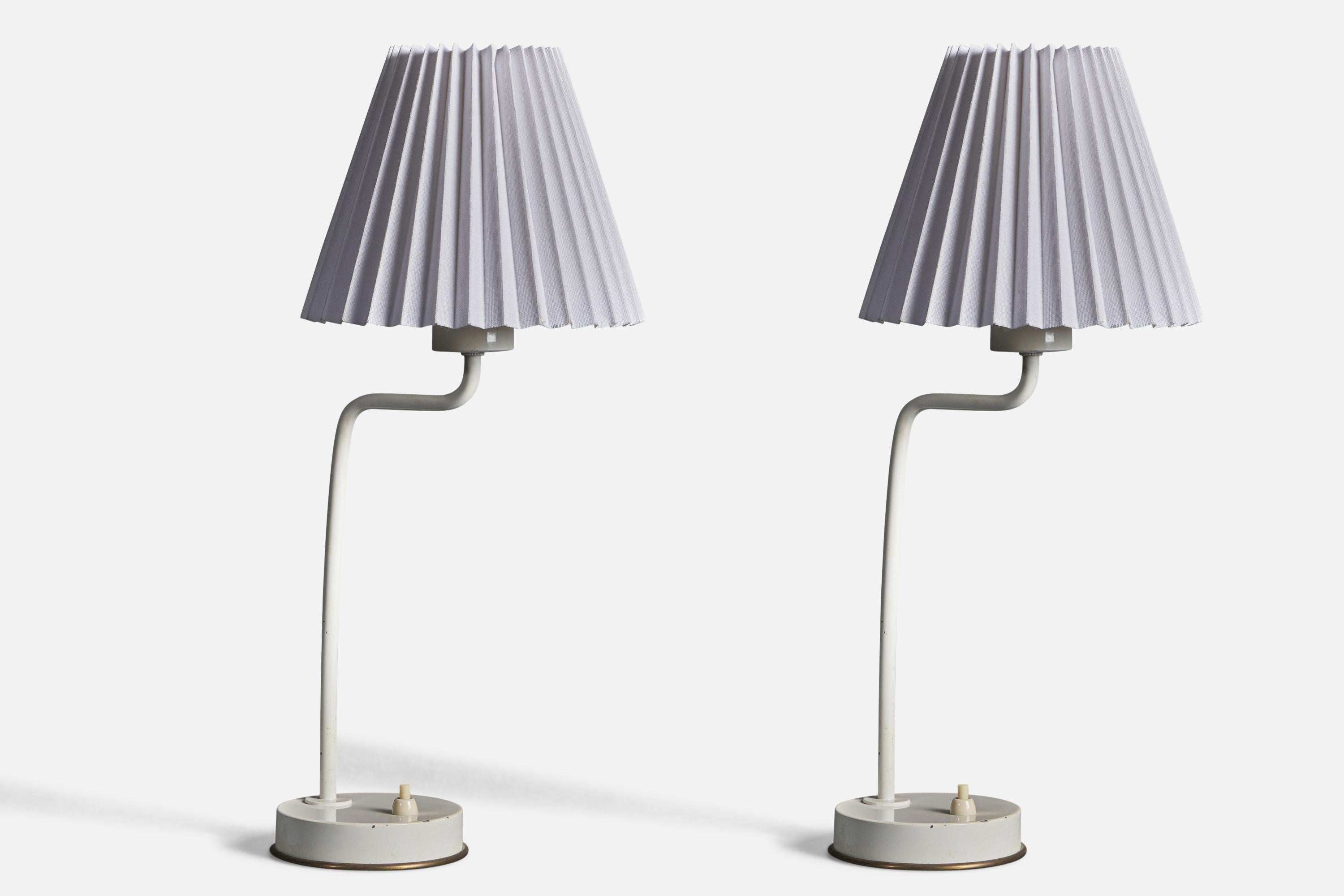 A pair of table lamps, designed by Hans-Agne Jakobsson for his own firm in Markaryd, Sweden. c. 1970s. Labeled. 
Condition: Good Wear consistent with age and use. 
Dimensions of Lamp (inches): 13.75” H x 4.4” W x 5.5” D 
Dimensions of Shade