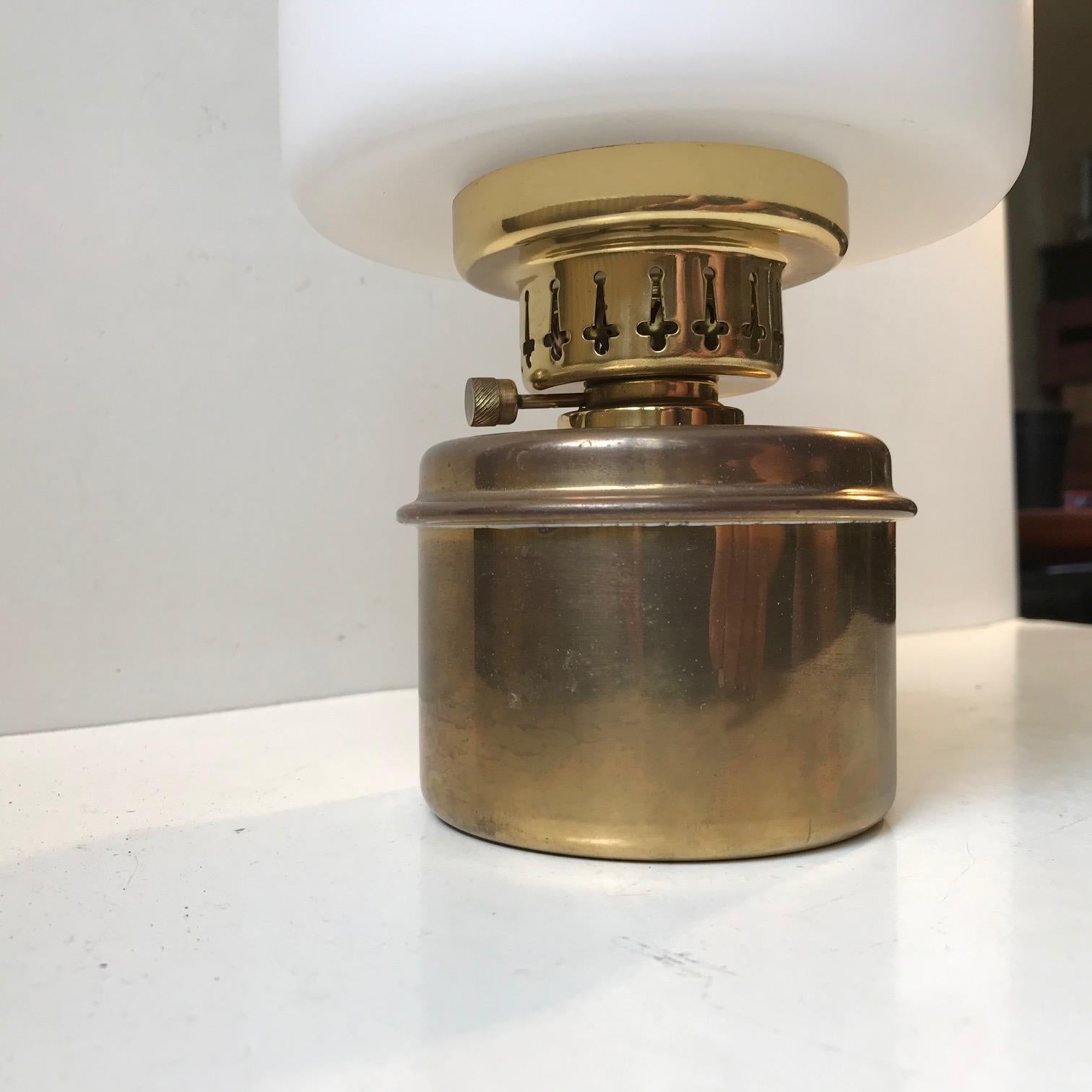 A Kerosene / table oil lamp model L 178/V 382. Designed during the late 1950s by Hans-Agne Jakobsson for his own company Markaryd AB in Sweden. This is a rare version featuring cased opaline glass. These were initially made for a nautical/maritime