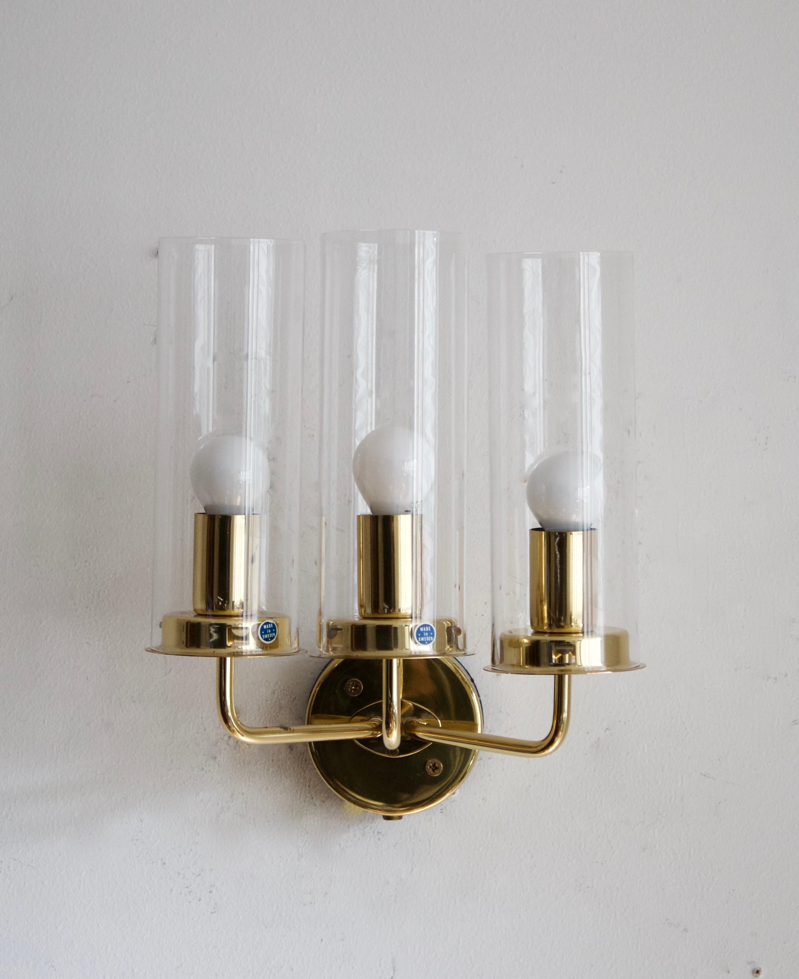 A pair of three-armed wall lights, designed by Hans-Agne Jakobsson for his own firm in Markaryd, Sweden. c. 1960s. Original glass diffusers.
