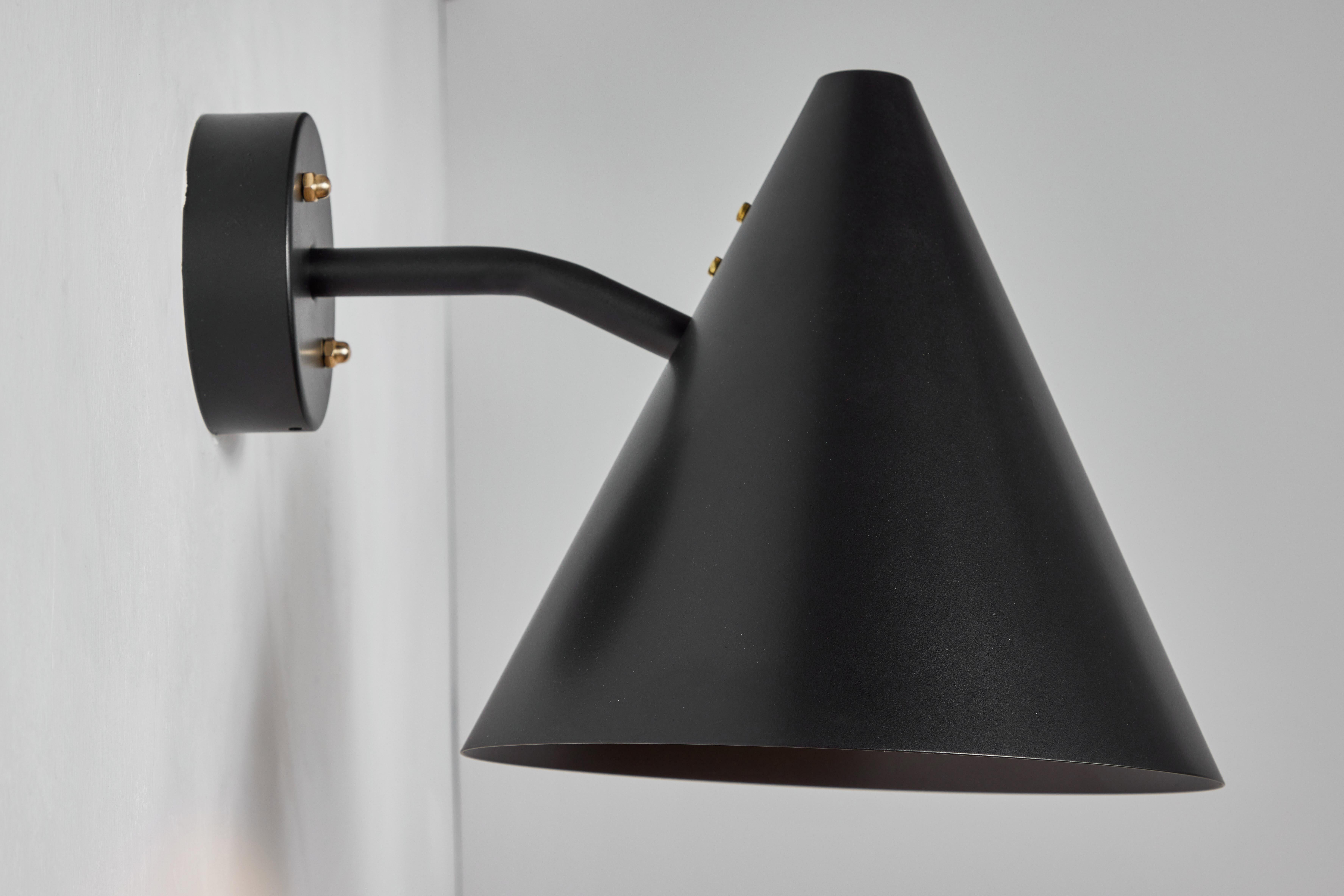 Hans-Agne Jakobsson 'Tratten' outdoor sconce in black.  An exclusive made for U.S. and UL listed authorized re-edition of the classic Swedish design executed in black painted metal shade with black painted interior and brass hardware. Suitable for