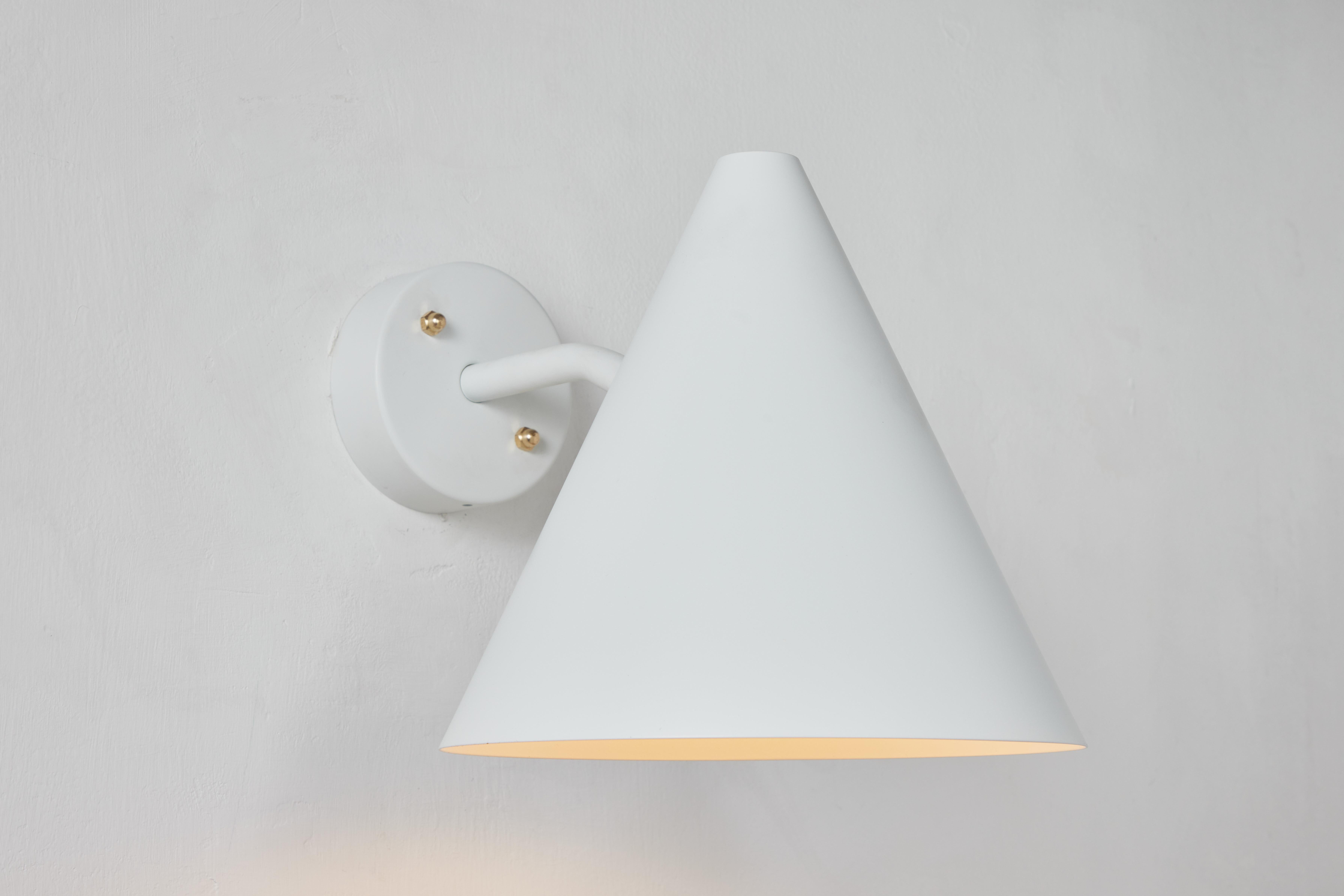 Hans-Agne Jakobsson 'Tratten' outdoor sconce in white. 

An exclusive made for U.S. and UL listed authorized re-edition of the classic Swedish design executed in white painted metal shade with white painted interior and brass hardware. Suitable for