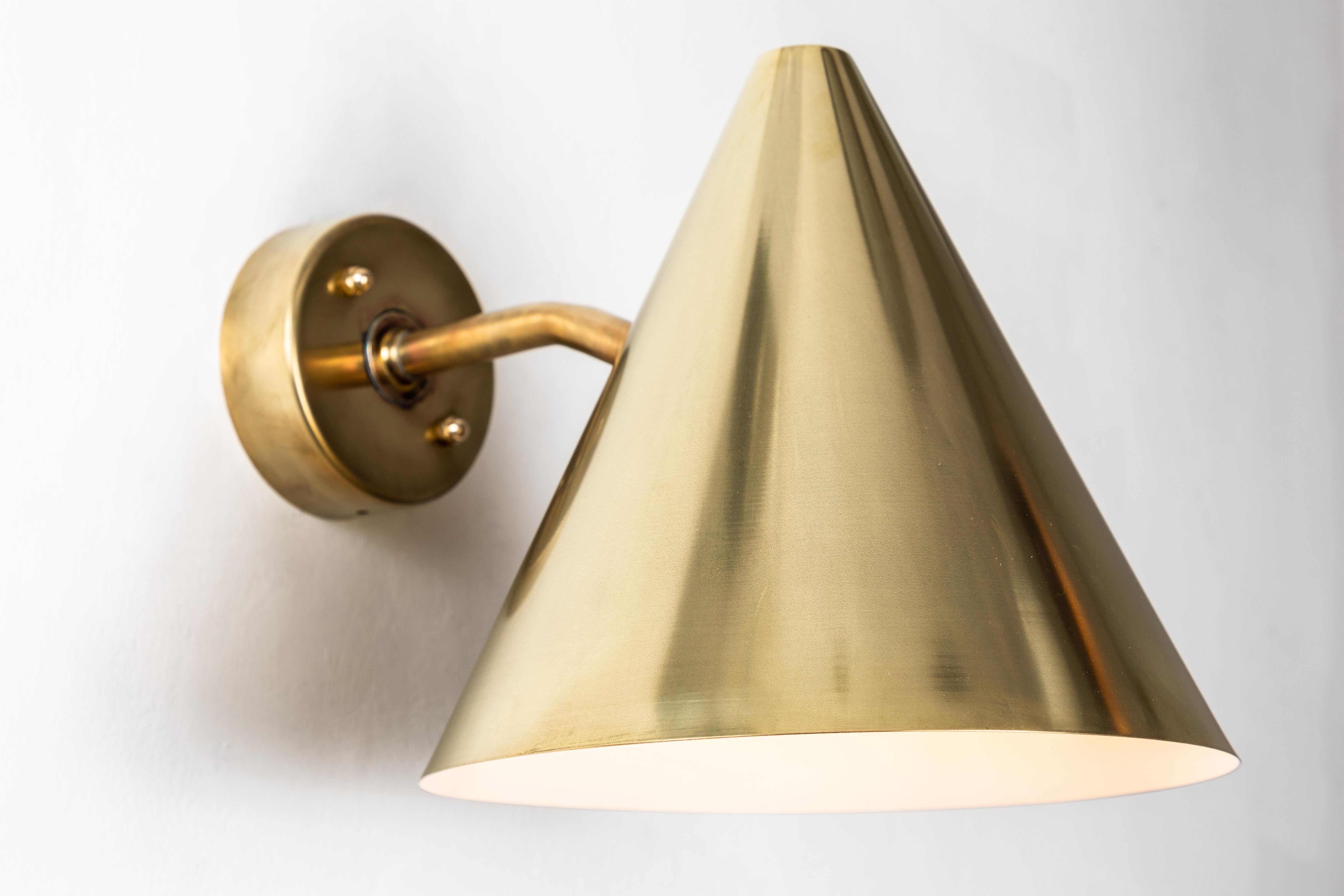 Pair of Hans-Agne Jakobsson 'Tratten' Raw brass outdoor sconces. An exclusive made for U.S. and UL listed authorized re-edition of the classic Swedish design executed in raw un-lacquered polished brass with white painted interior. Suitable for both