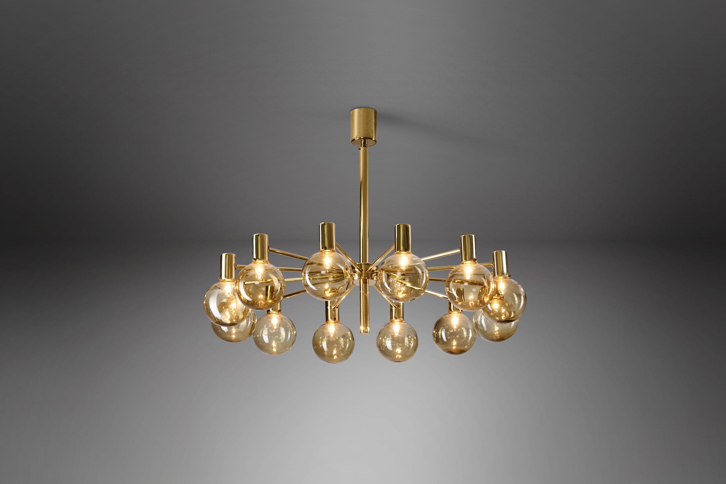 This marvellous, brass twelve-light chandelier was created in what we now call “the golden age of Scandinavian design”. Hans-Agne Jakobsson was the great Swedish master of lighting, designing some of the most recognizable Mid-Century Modern lamps of