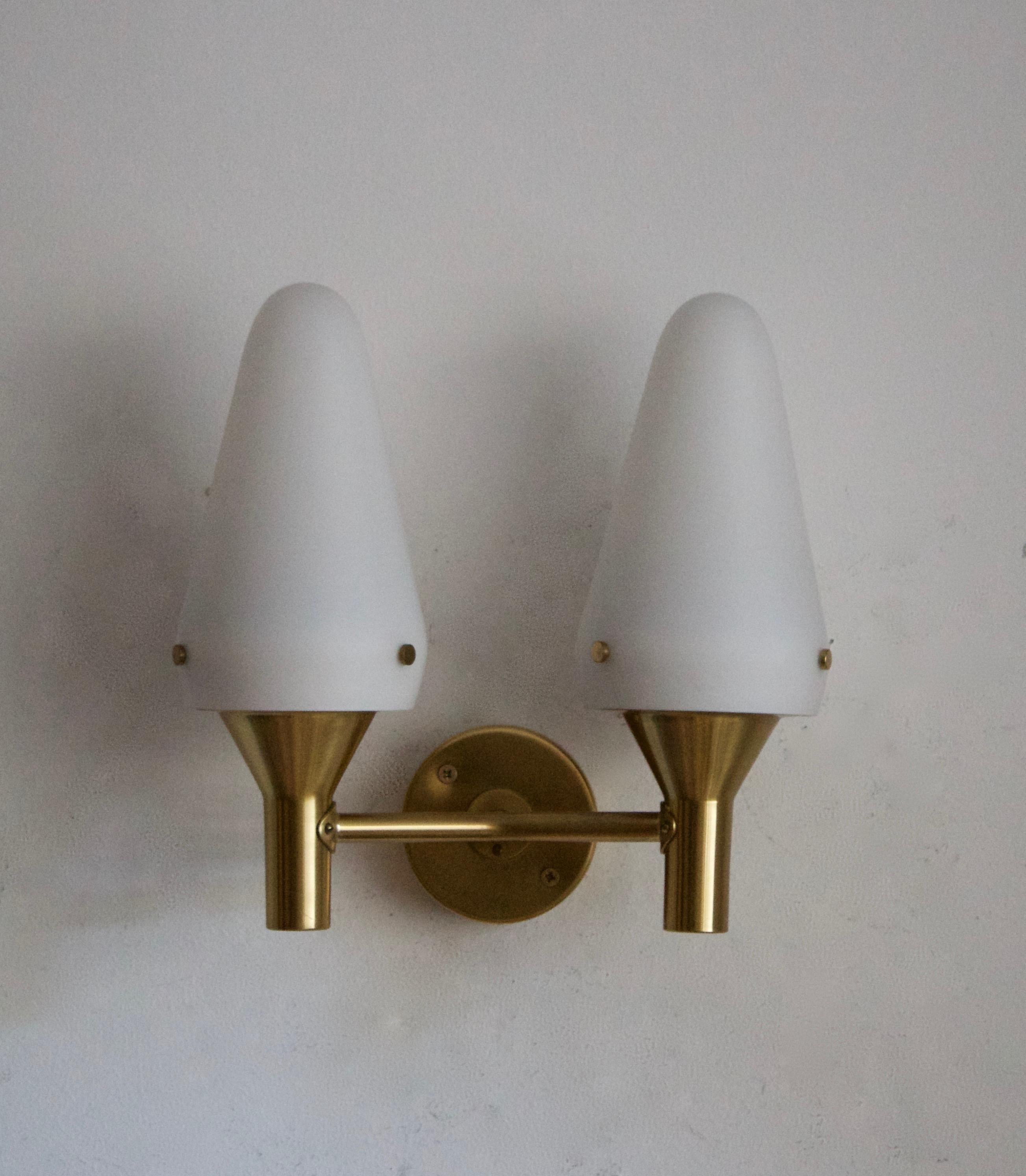 A two-armed wall light, designed by Hans-Agne Jakobsson for his own firm in Markaryd, Sweden. c. 1970s. Labeled.