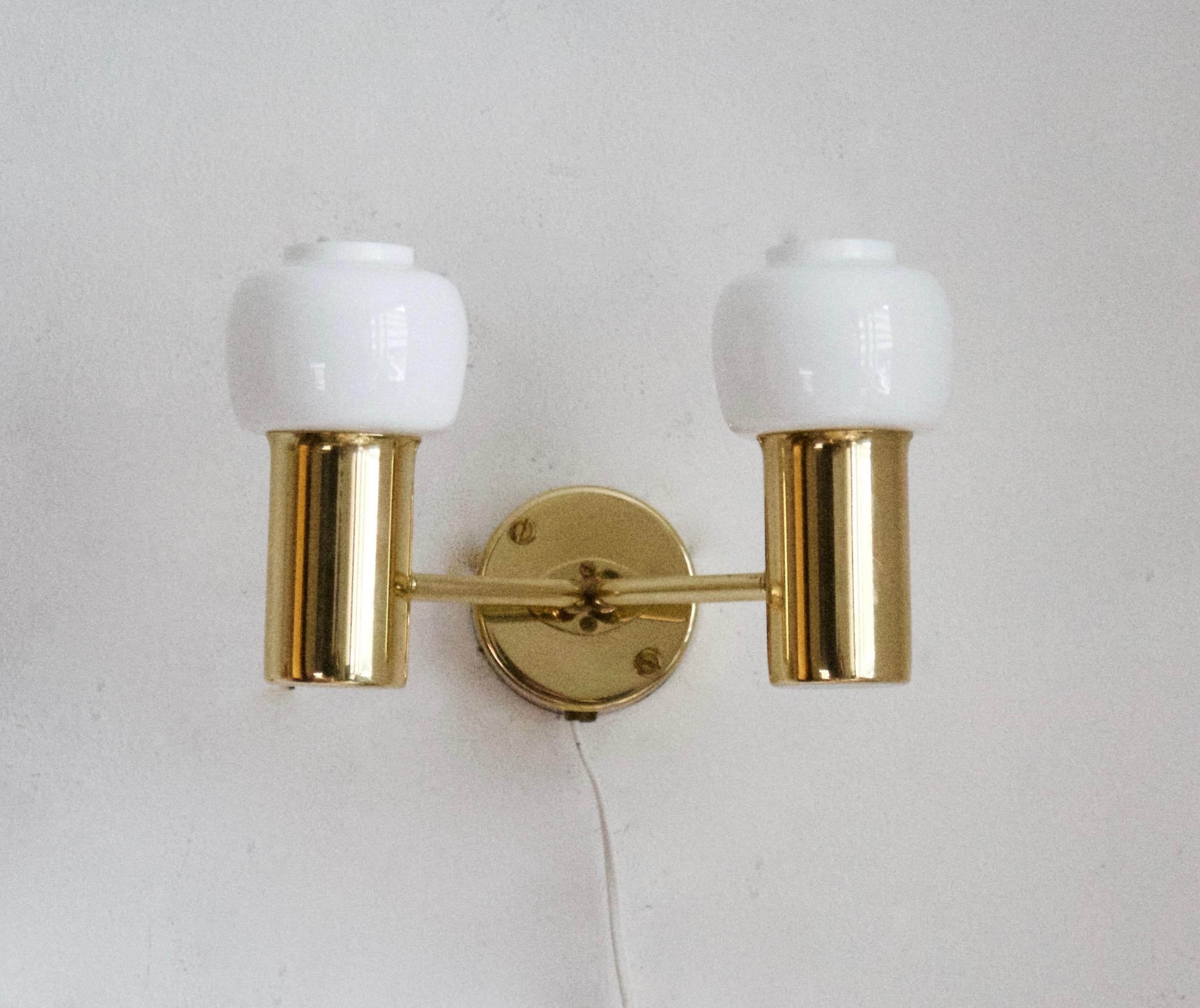 A pair of two-armed wall lights, designed by Hans-Agne Jakobsson for his own firm in Markaryd, Sweden. c. 1970s. Labeled.
