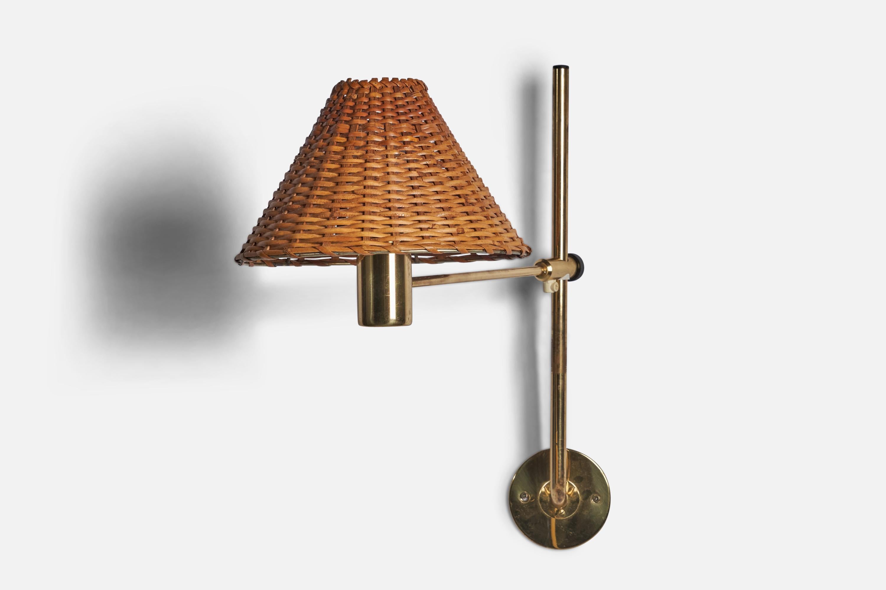 An adjustable brass and rattan wall light designed and produced by Hans-Agne Jakobsson, Sweden, 1960s.

Overall Dimensions (inches): 22” H x 10” W x 17” D
Back Plate Dimensions (inches): 4” Diameter
Bulb Specifications: E-26 Bulb
Number of Sockets: