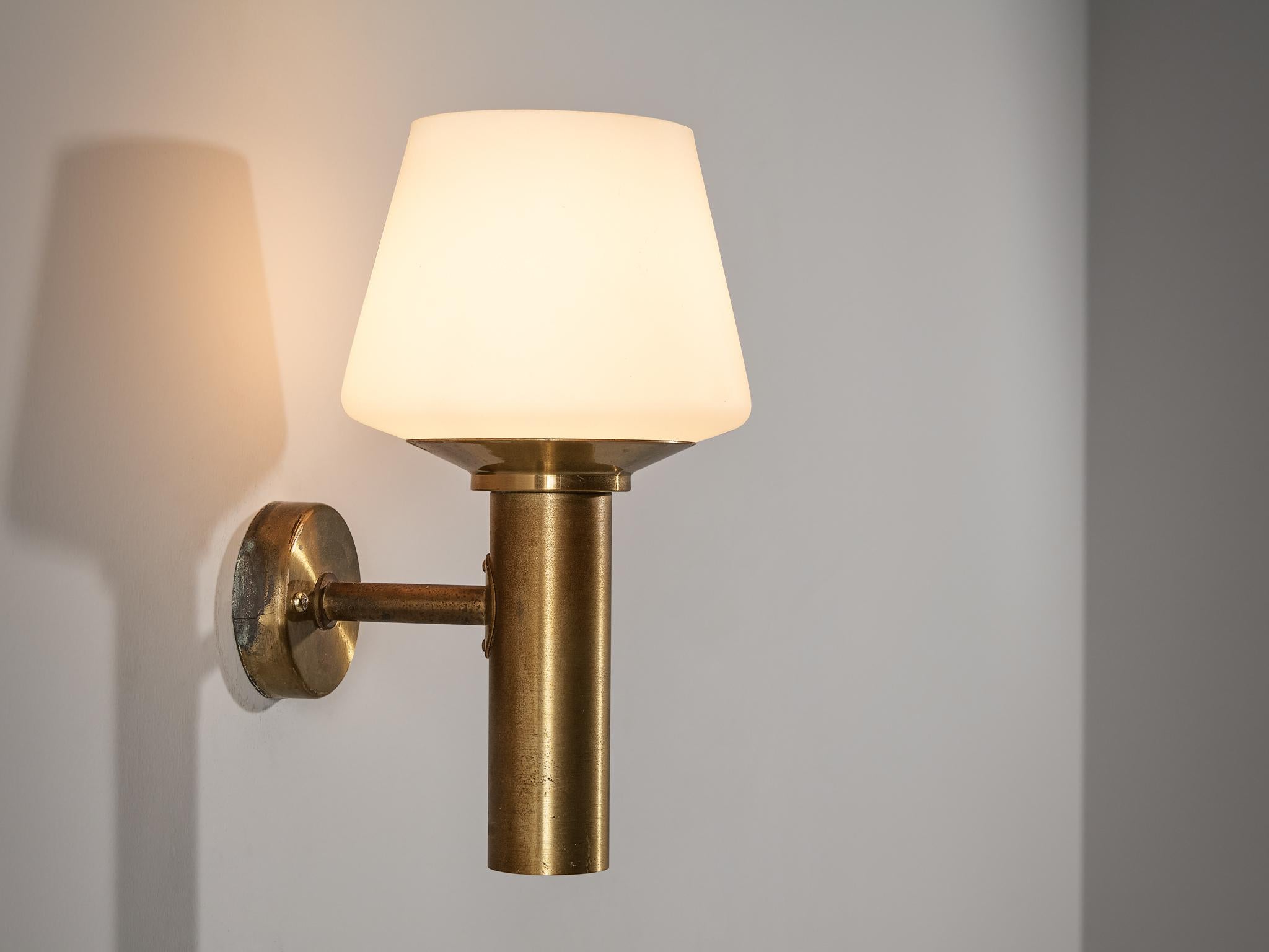 Hans-Agne Jakobsson for Hans-Agne Jakobsson AB in Markaryd, wall light, brass, opaline glass, Sweden, 1960s 

This elegant wall light is designed by Hans-Agne Jakobsson around the 60s. The opaline glass sphere, displaying a natural and soft glow, is