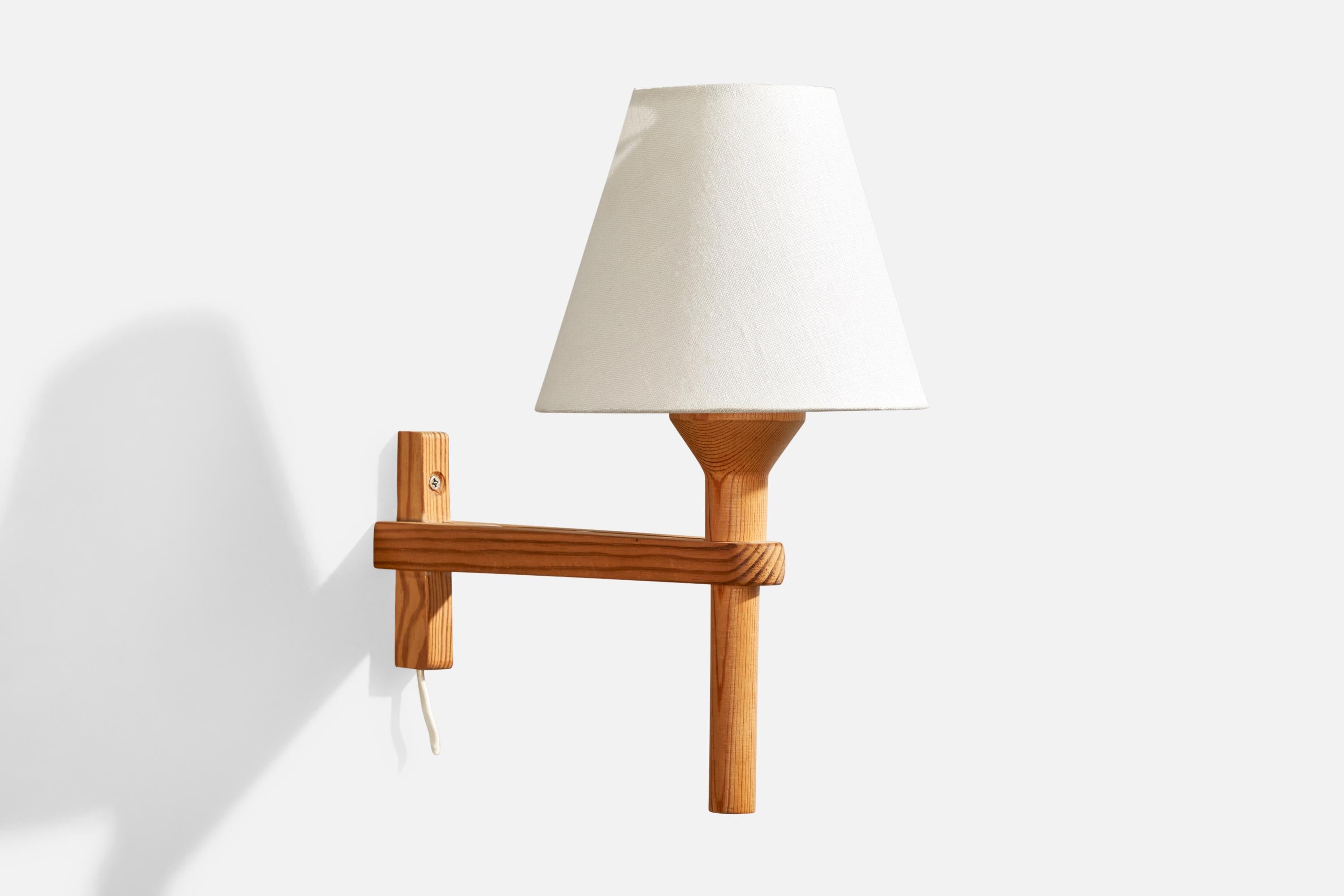 A pine and fabric wall light designed and produced by Hans-Agne Jakobsson, Sweden, 1970s.

Overall Dimensions (inches): 11.25” H x 6.125” W x 11” D

Back Plate Dimensions (inches): 4” H x 1.65” W x 0.9” D

Bulb Specifications: E-26 Bulb

Number of