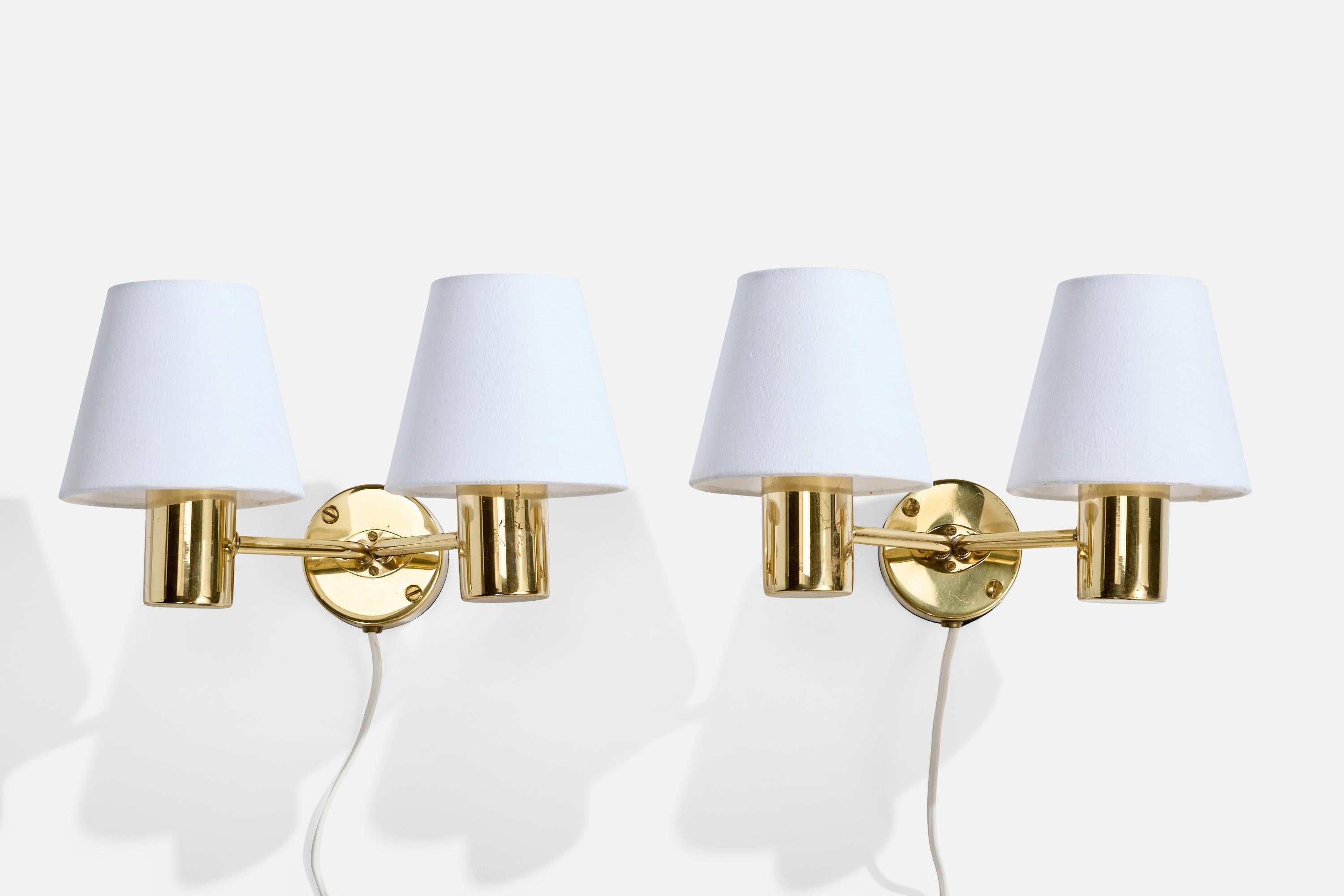 A pair of brass and white fabric wall lights designed and produced in Sweden, c. 1960s.

Overall Dimensions (Inches): 7” H x 11.75” W x 9” D

Back Plate Dimensions (Inches): 3.2” H x 3.2“ W x 1.45” D

Bulb Specifications: E-14

Number of Sockets