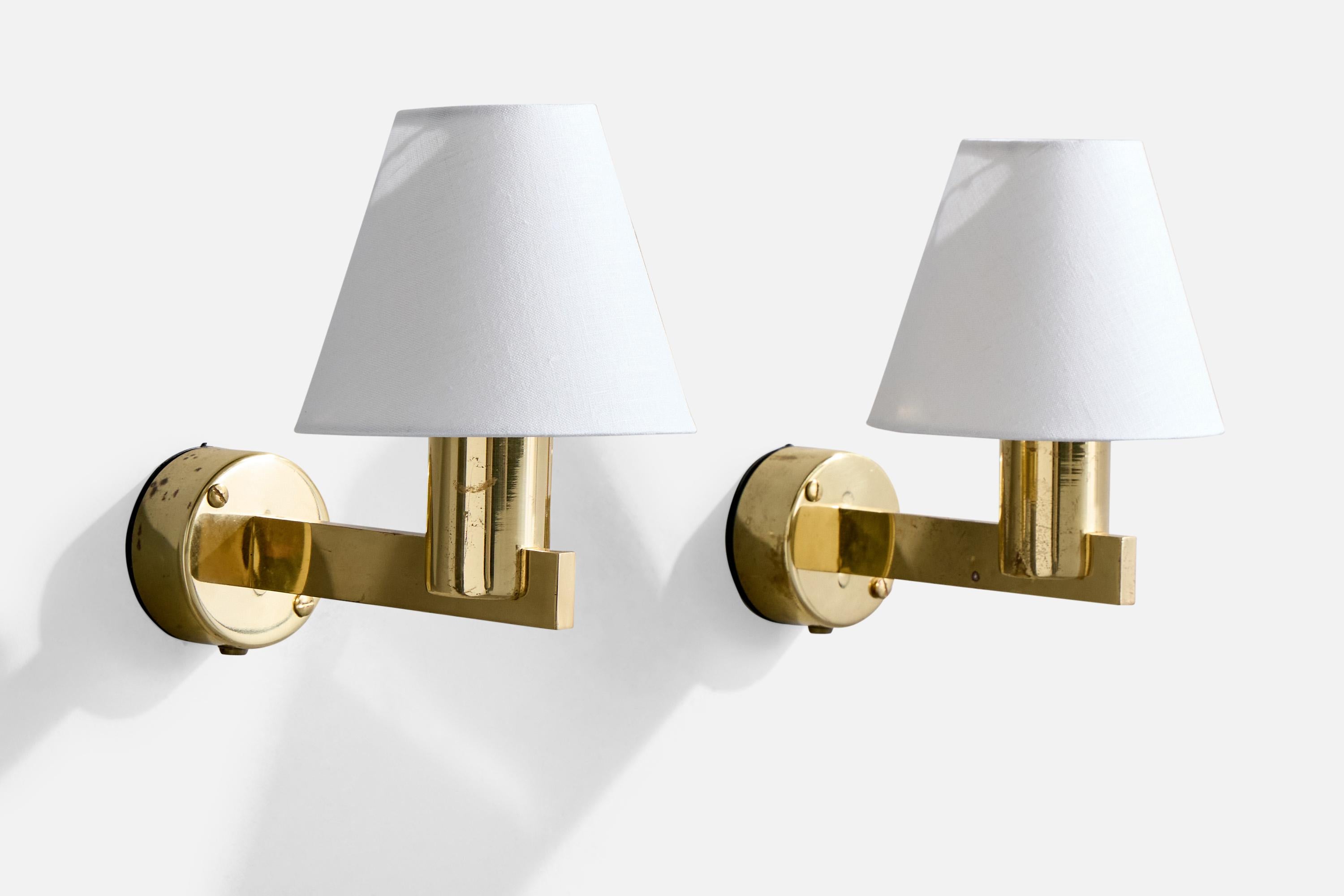 A pair of brass and white fabric wall lights designed and produced in Sweden, c. 1960s.

Overall Dimensions (Inches): 9.25” H x 6” W x 9.8” D

Back Plate Dimensions (Inches): 3.25” H x 3.25“ W x 1.625” D

Bulb Specifications: E-26 candle

Number of