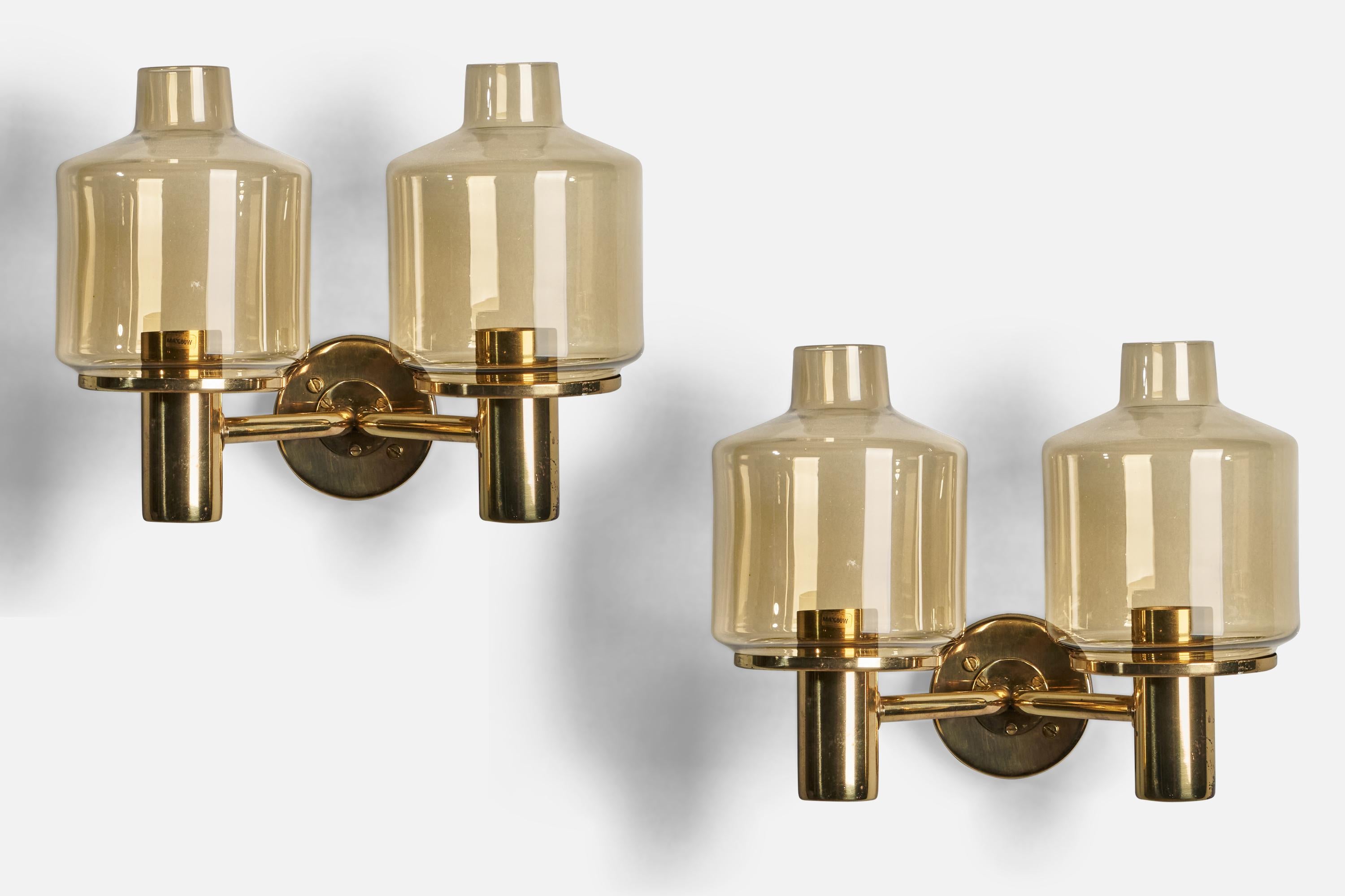 A pair of two-armed brass and yellow-coloured glass wall lights designed and produced in Sweden, 1970s.

Overall Dimensions (inches): 11.5” H x 14” W x 9.25” D
Back Plate Dimensions (inches): 4” Diameter
Bulb Specifications: E-26 Bulb
Number of