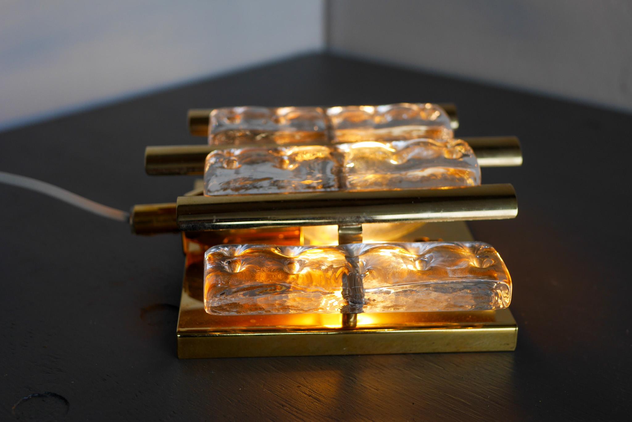 An amazing wall sconce made by the talented Hans-Agne Jakobsson in cooperation between Markaryd and the prestigious Orrefors. This wall lamp which will illuminate your space and create a very special feeling. It has a brass metal based which has