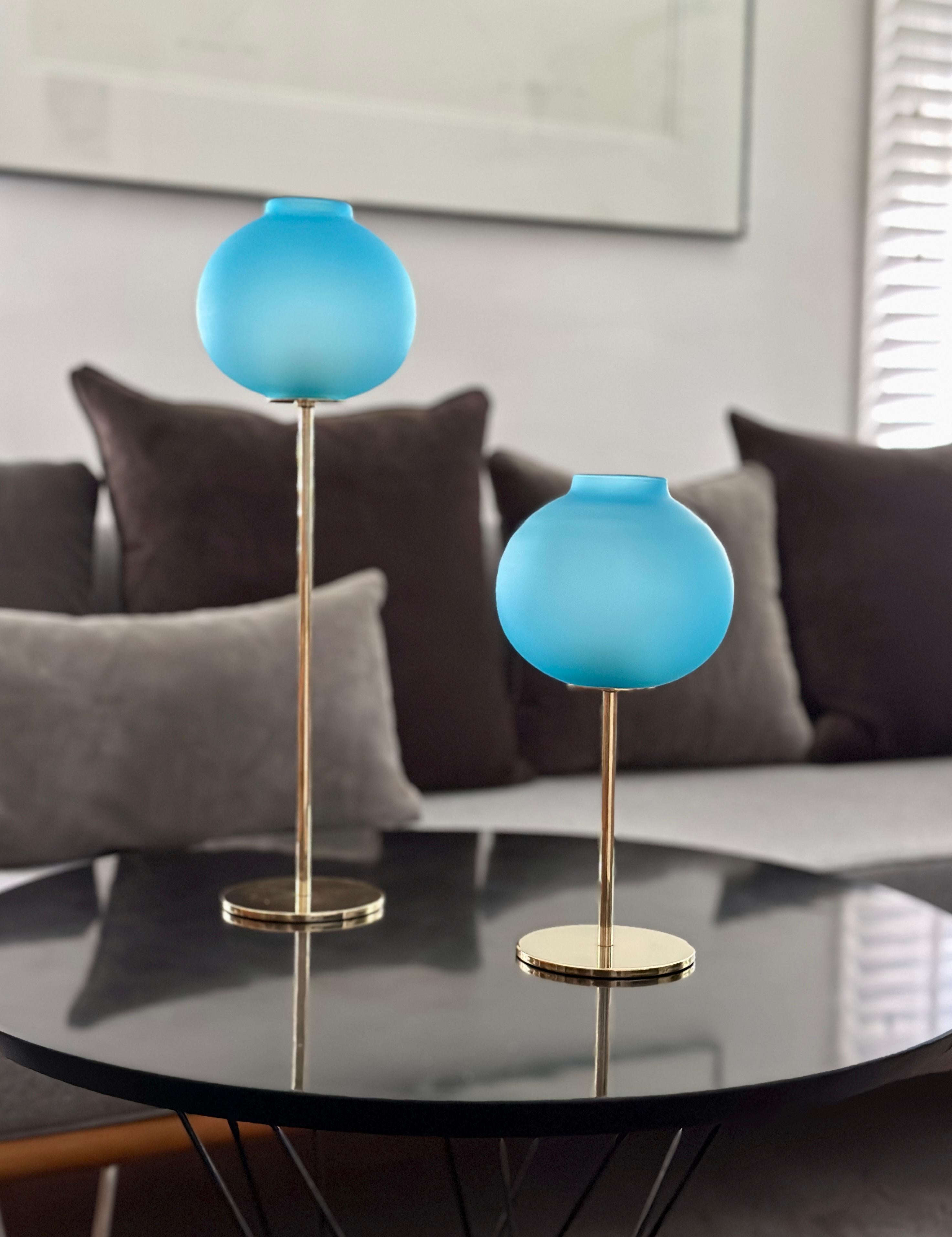 DESCRIPTION

A pair of candlesticks designed by Hans-Agne Jakobsson and produced by his own company, Hans-Agne Jakobsson AB sometime between 1960 - 1970. The candlesticks are solid brass with blue opaque glass globes. The tallest candlestick