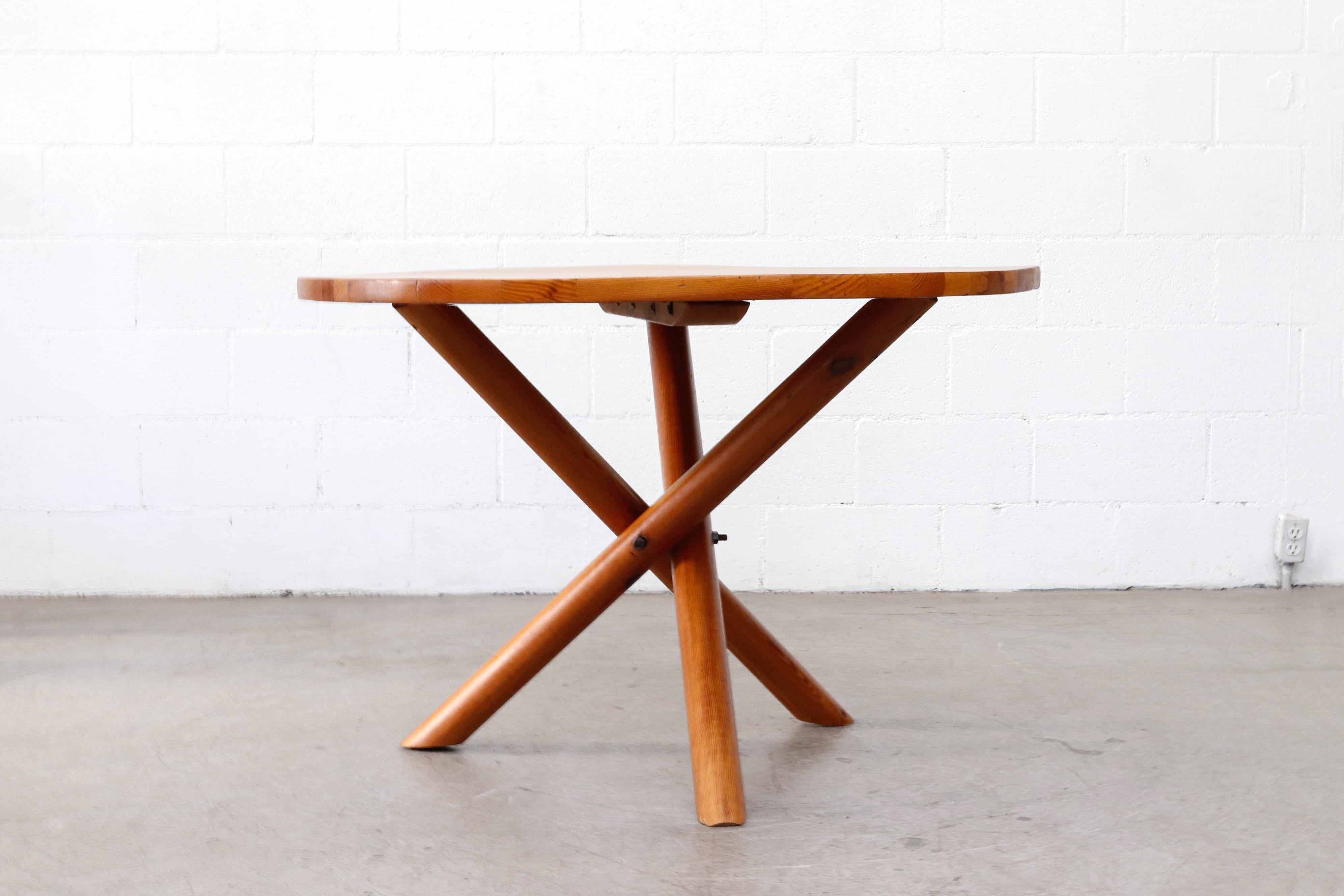 Handsome Hans Bellman style pine center or dining table with crossing tripod base. In original condition with visible warping to top. Wabi-Sabi nice!