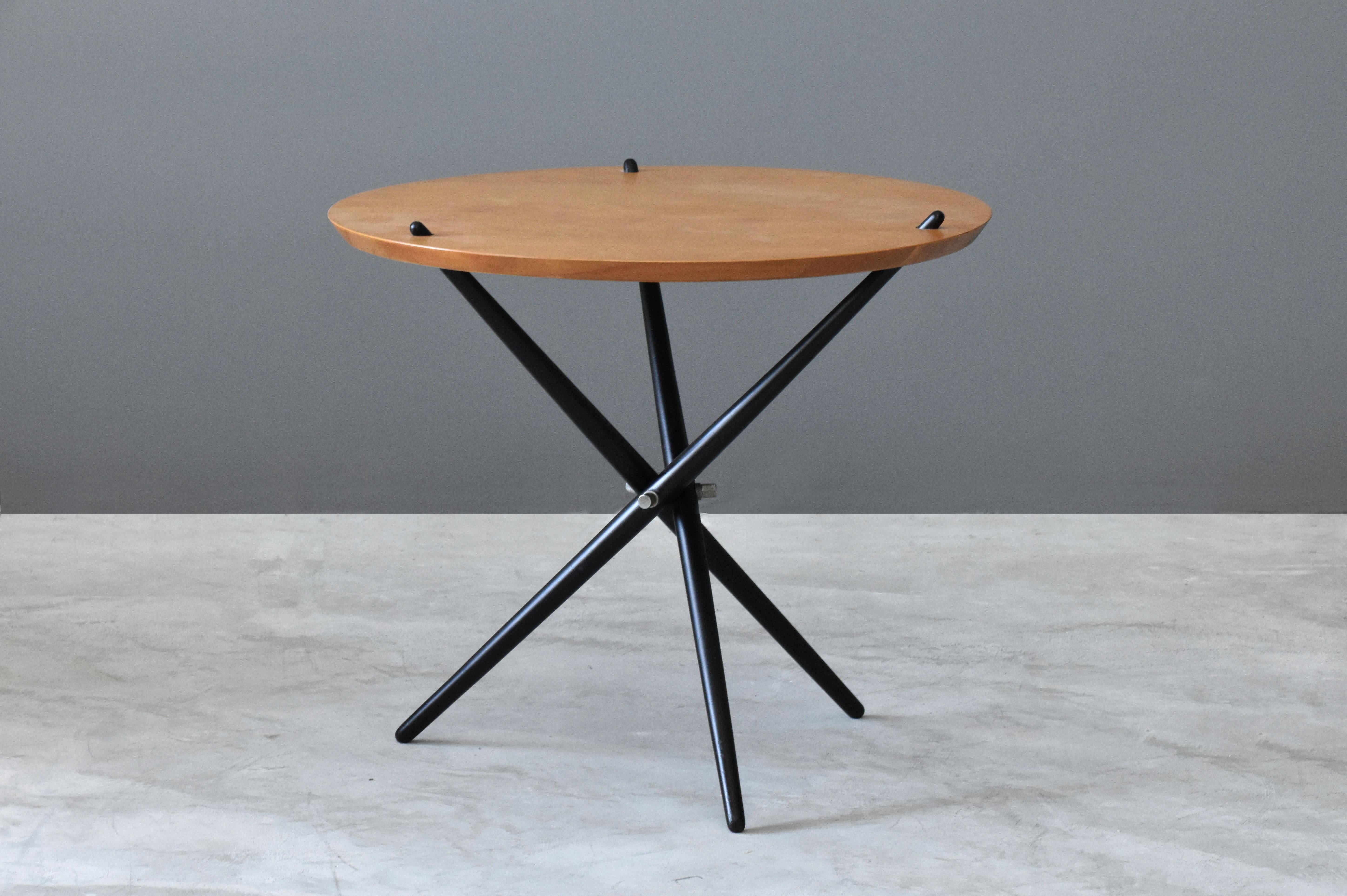 An example of swiss designer Hans Bellmanns iconic tripod side table. Designed in 1948 and produced by Knoll, circa 1950s. 

Other designers of the period include Pierre Jeanneret, Le Corbusier, Charles and Ray Eames, Mies van der Rohe and Arne