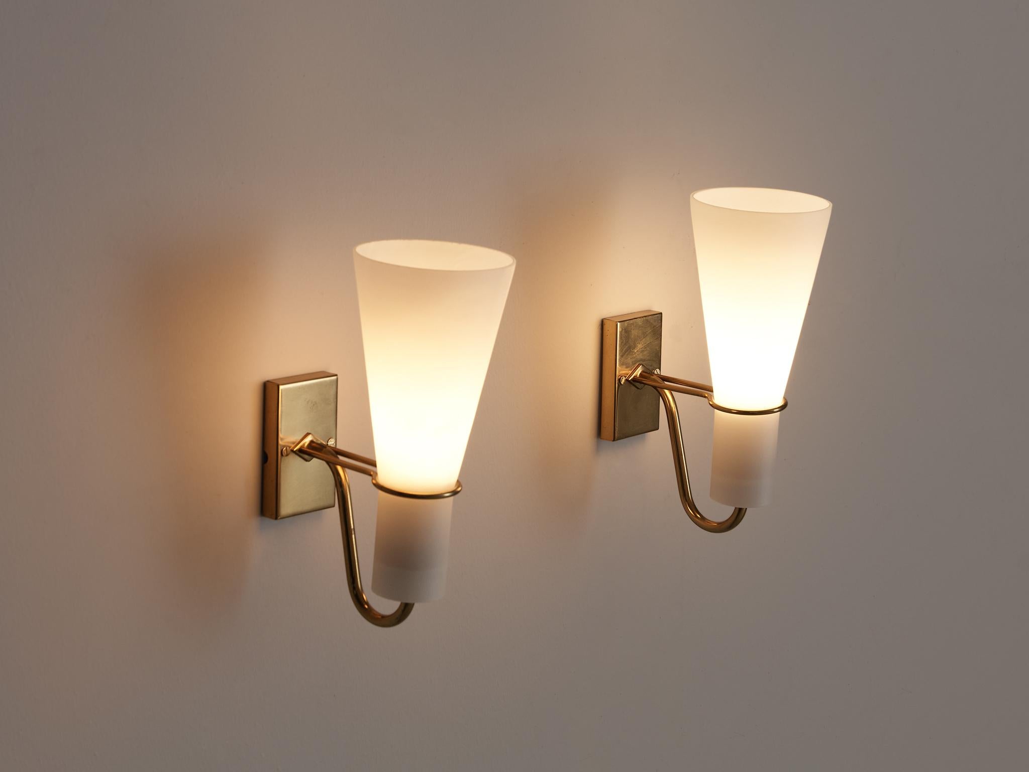 Hans Bergström for ASEA Belysning, wall lights, brass, matted glass, Sweden, 1950s

These cone-shaped wall lights are held by filigree brass details ending in a small rectangular plate. Due to the matted glass the light gets smooth and cozy. The