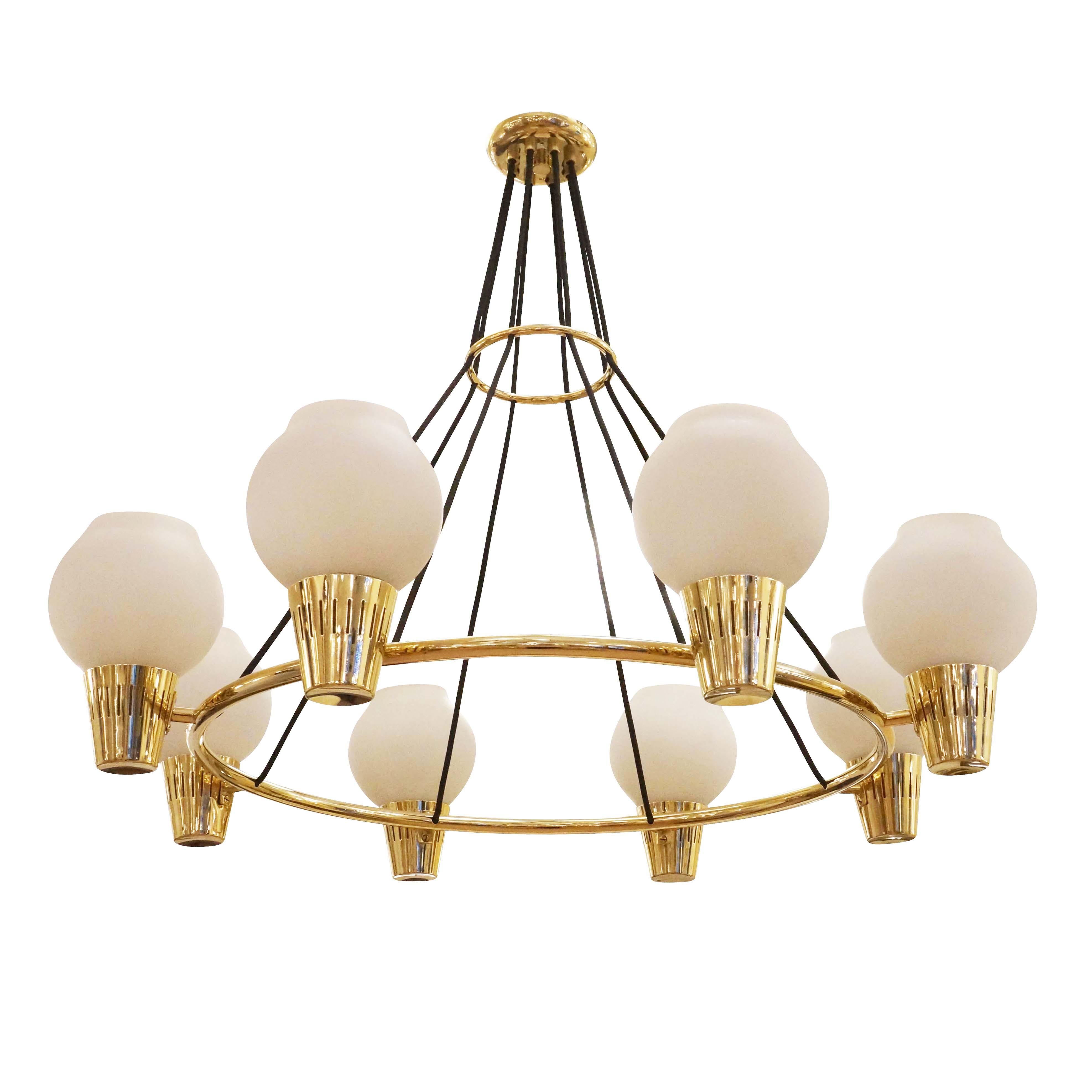 Swedish Mid-Century Modern chandelier designed by Hans Bergstrom for Ystad. Features eight frosted glass diffusers on a polished brass frame. Height is adjustable by altering the cord length.   

Condition: Excellent vintage condition, minor wear