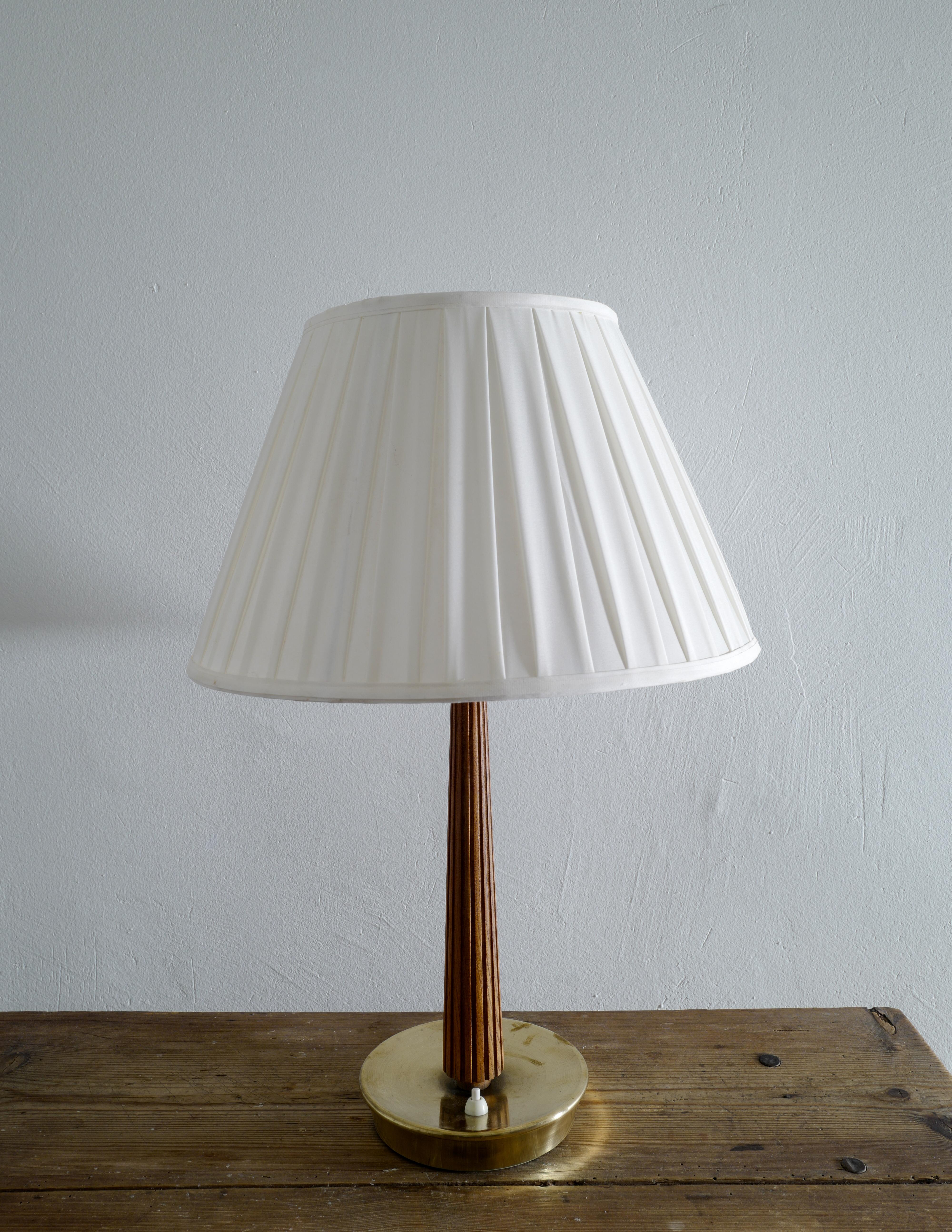 Rare table lamp in stained oak and brass designed by Hans Bergström and produced by ASEA in Sweden. In good and original condition and stamped correctly. The fabric shade is included in the price. 

Measurements: 
With the shade: Height: 58 cm,