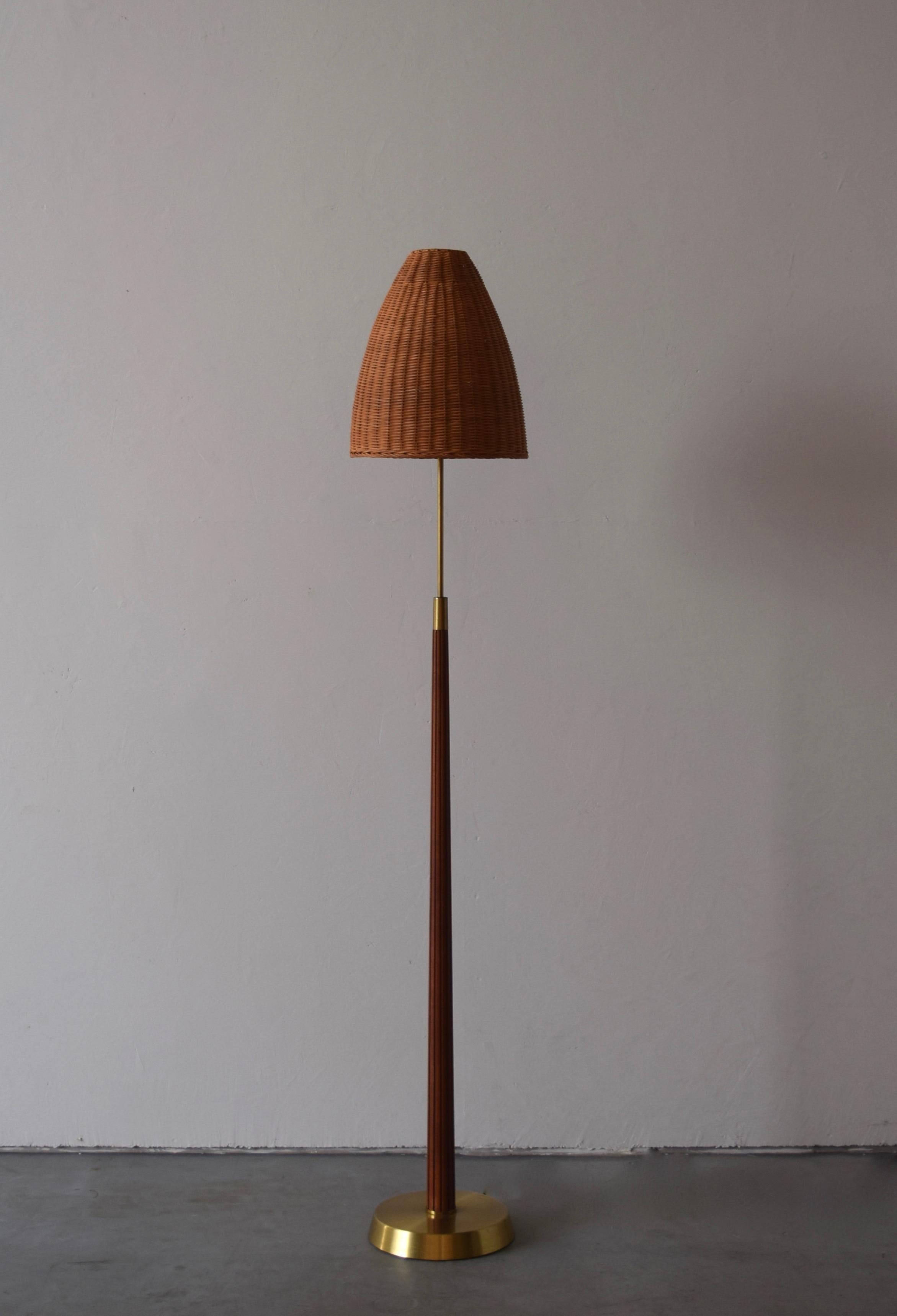 A floor lamp. Designed by Swedish Hans Bergström. Produced by ASEA, Sweden, 1950s. Stamped. With assorted vintage rattan lampshade.

Stated dimensions include lampshade.

