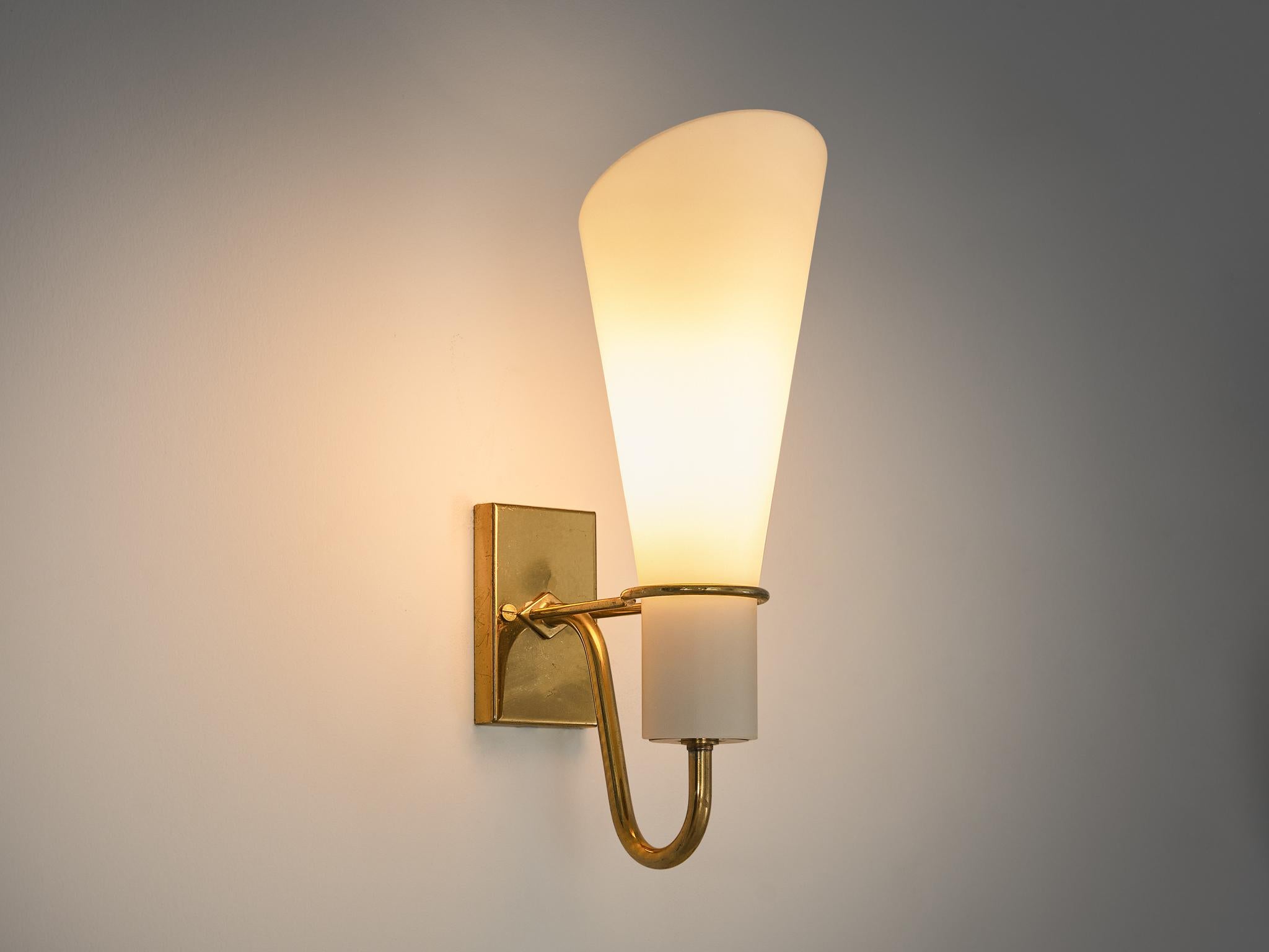 Hans Bergström for ASEA Belysning, wall light, brass, matted glass, Sweden, 1950s

This cone-shaped wall light is held by filigree brass details ending in a small rectangular plate. Due to the matted glass in opaque white the light gets smooth and