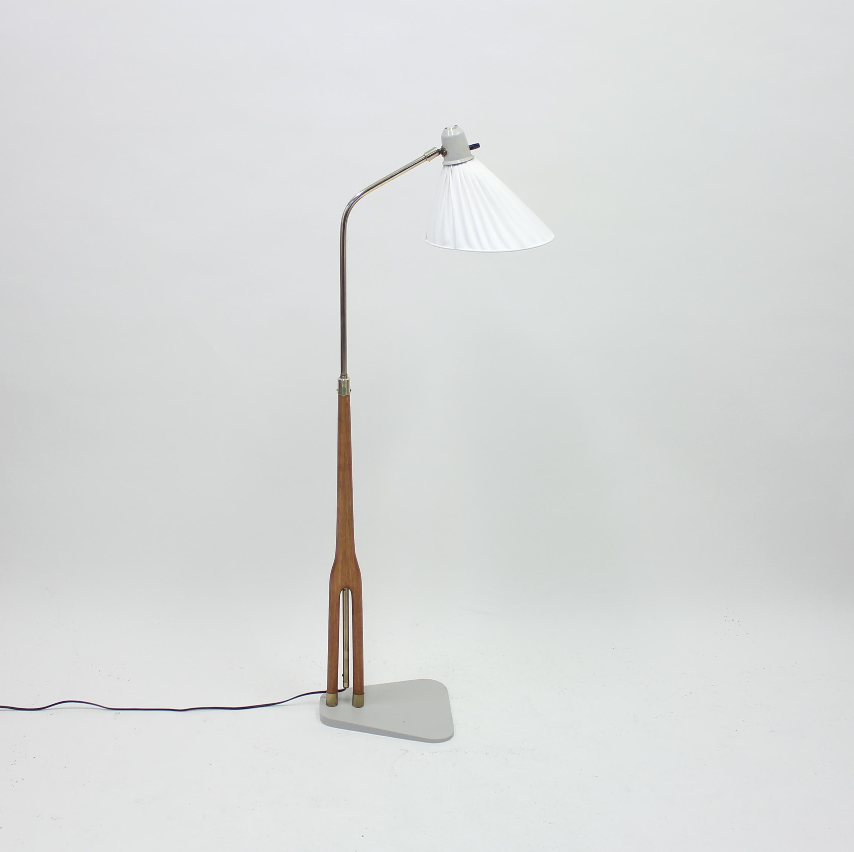 Very rare height adjustable floor lamp (between 123-143 cm) designed by Hans Bergström for ASEA in the 1950s. Newly grey coated base according to the original design. Shade with new fabric. Very good condition with light ware consistent with age and