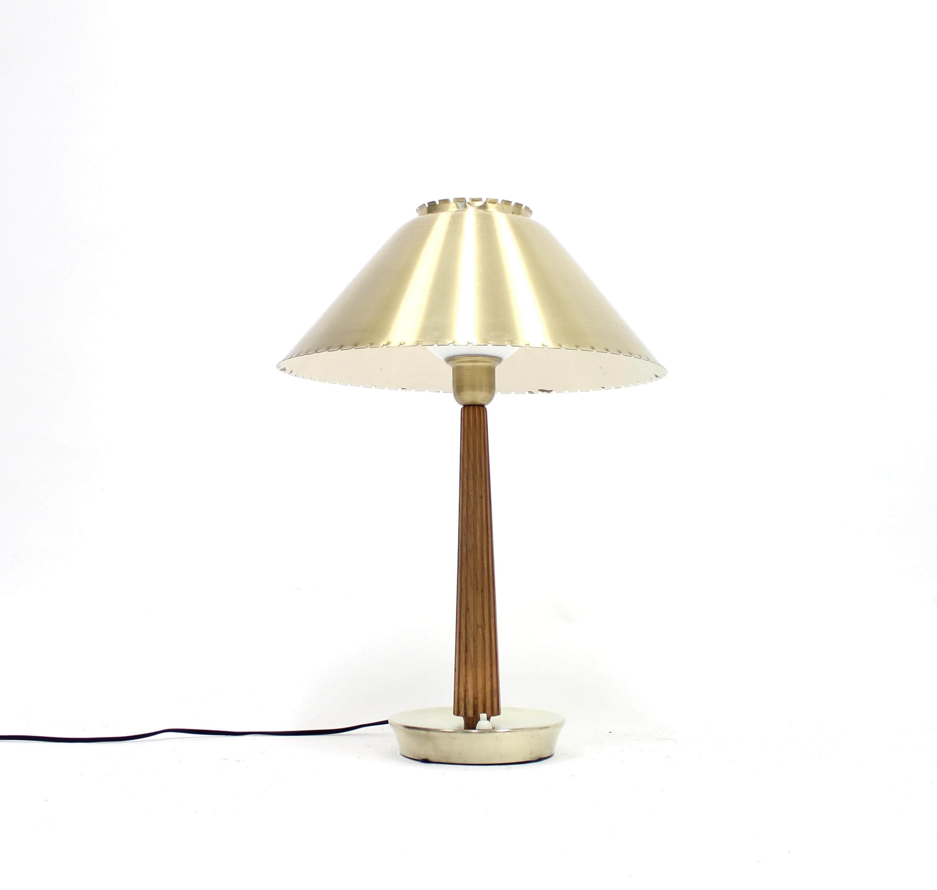 Table lamp designed by Hans Bergström for Swedish manufacturer ASEA in the 1950s. Brass base and shade with teak stem. Rewired with new plug. very good vintage condition with ware consistent with age and use.