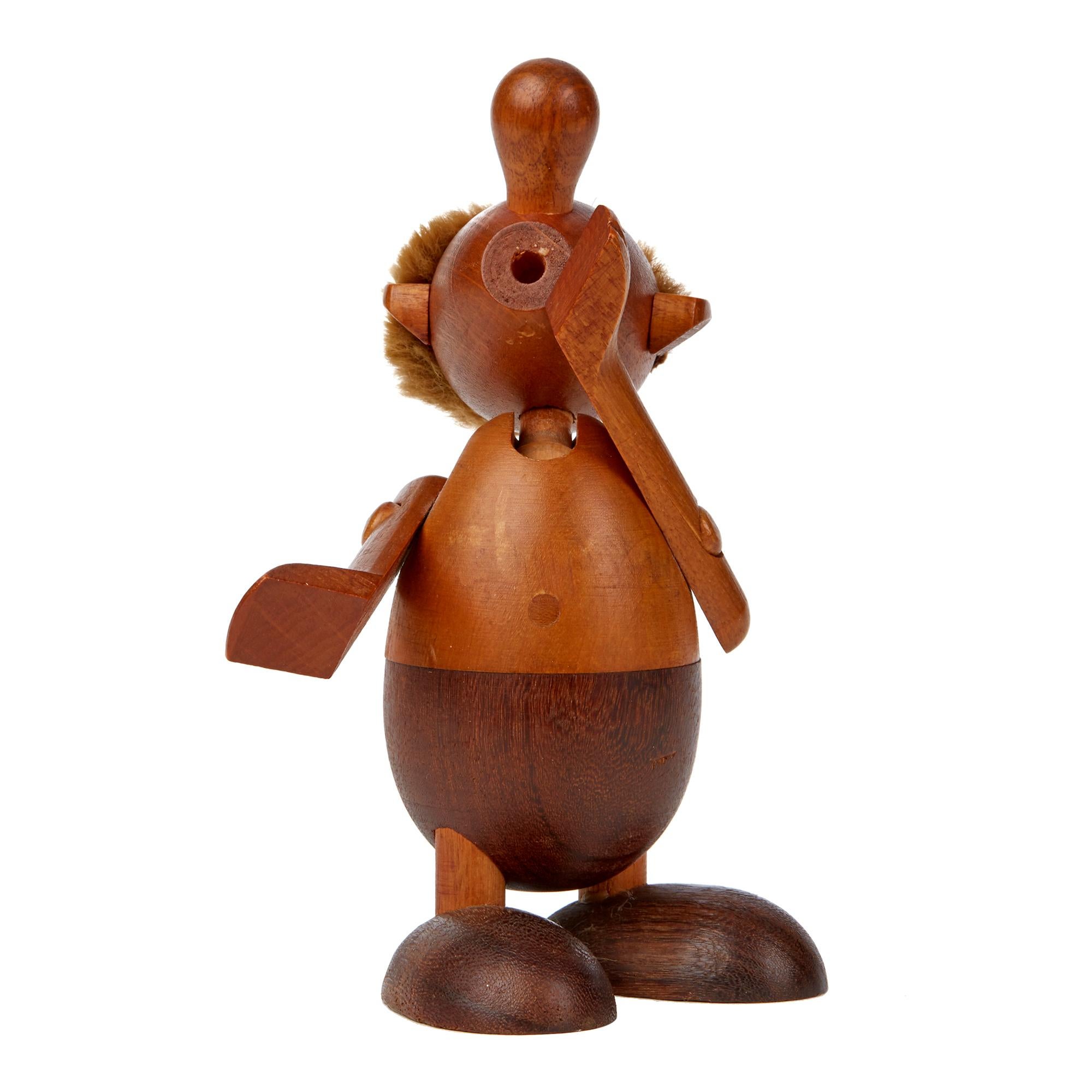 Delightful vintage Danish wooden Strit toy figure with moving limbs designed by Hans Bolling for Oskov & Co. dating from circa 1954. The wooden figure is made in two tones of wood and has a swiveling arms and a fully rotating head. The figure is