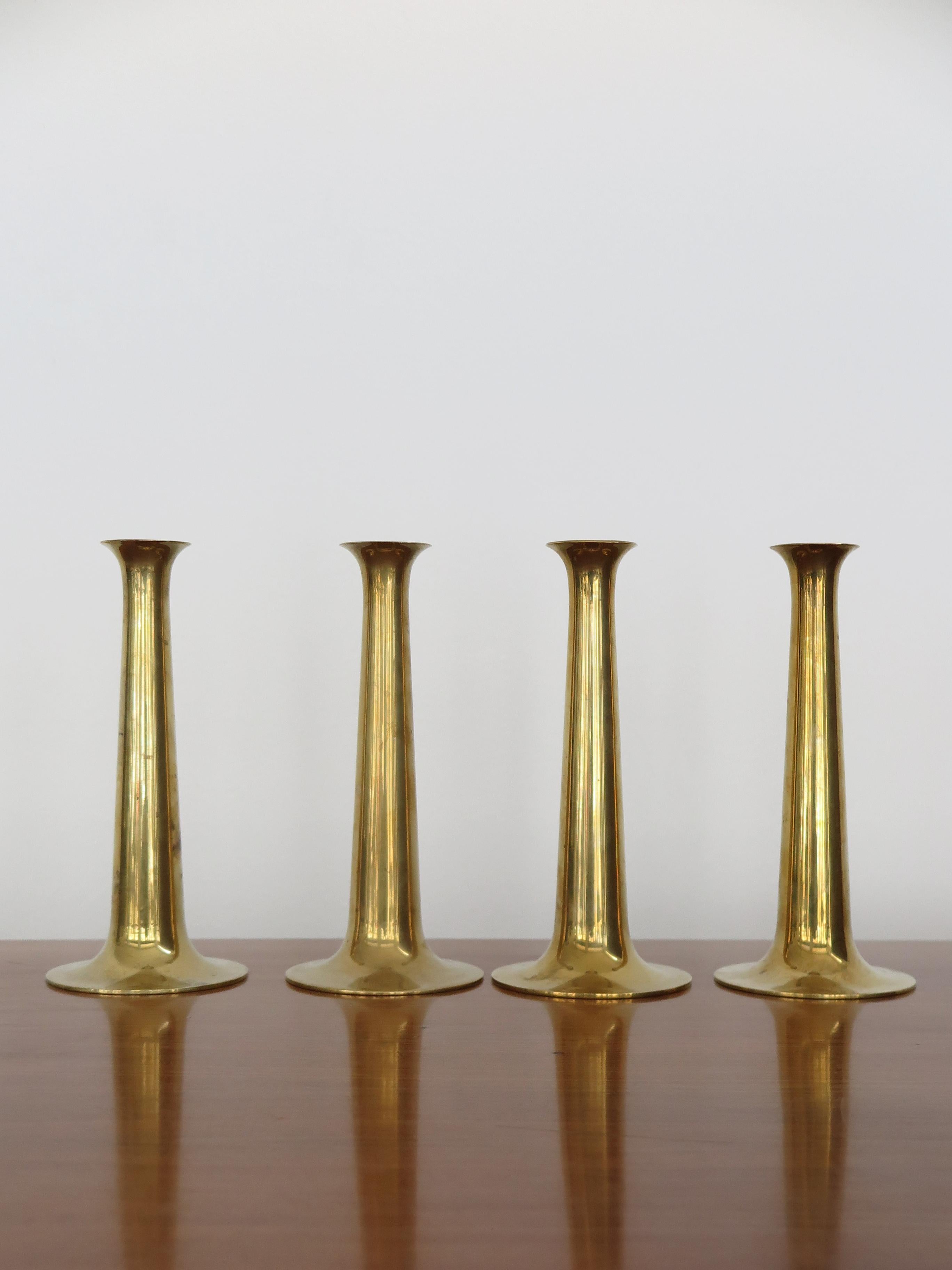Set of four Scandinavian midcentury modern design candlesticks candleholders designed by Hans Bolling and manufactured by Torben Orskov in Denmark, they are made from solid brass and feature the manufacturer's mark to each base, Denmark