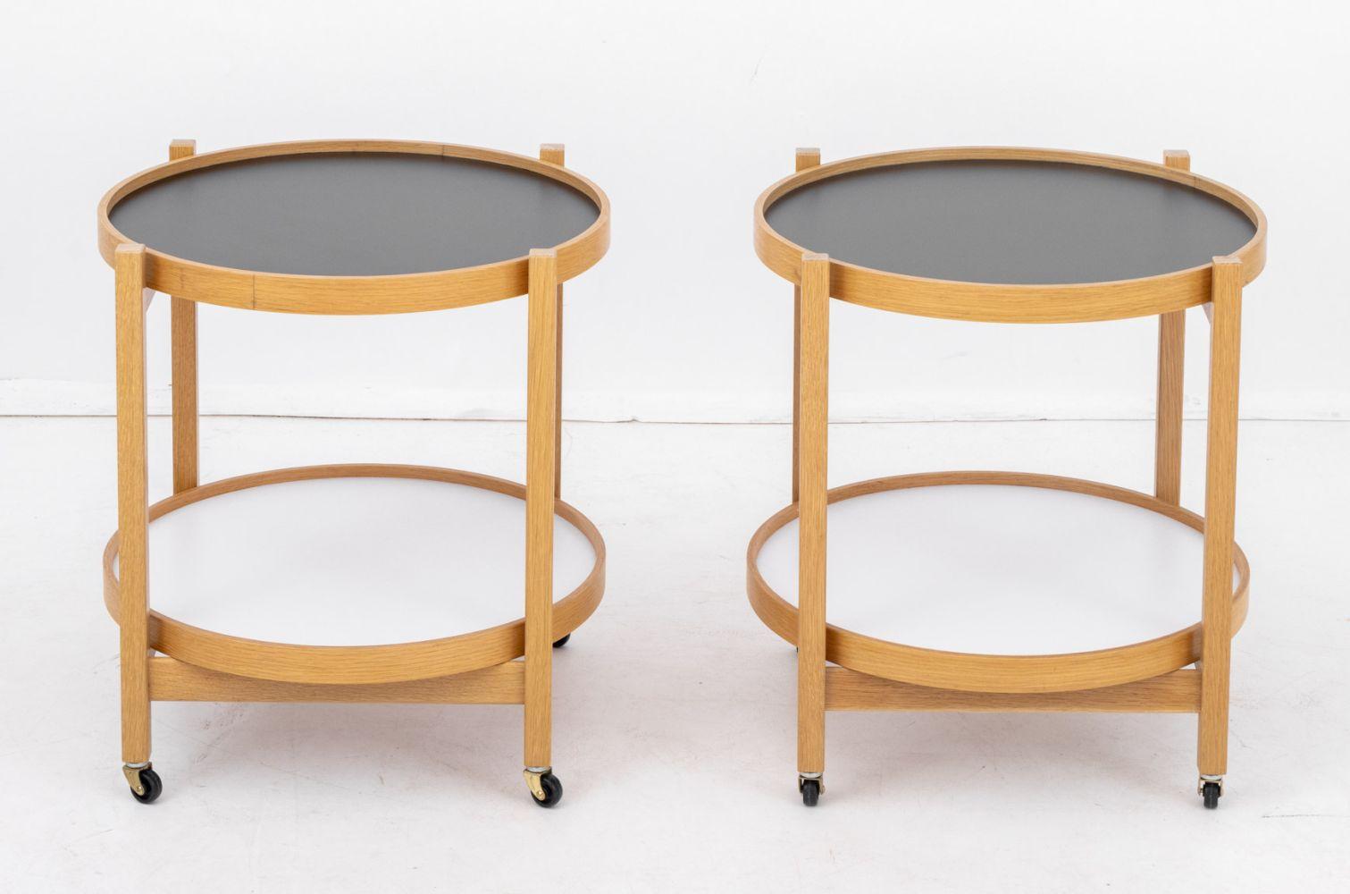 Pair of Hans Bolling Style Two-Tier Rolling Side Tables, each with wood frame, two removable circular tray tops, and on casters. 21.5