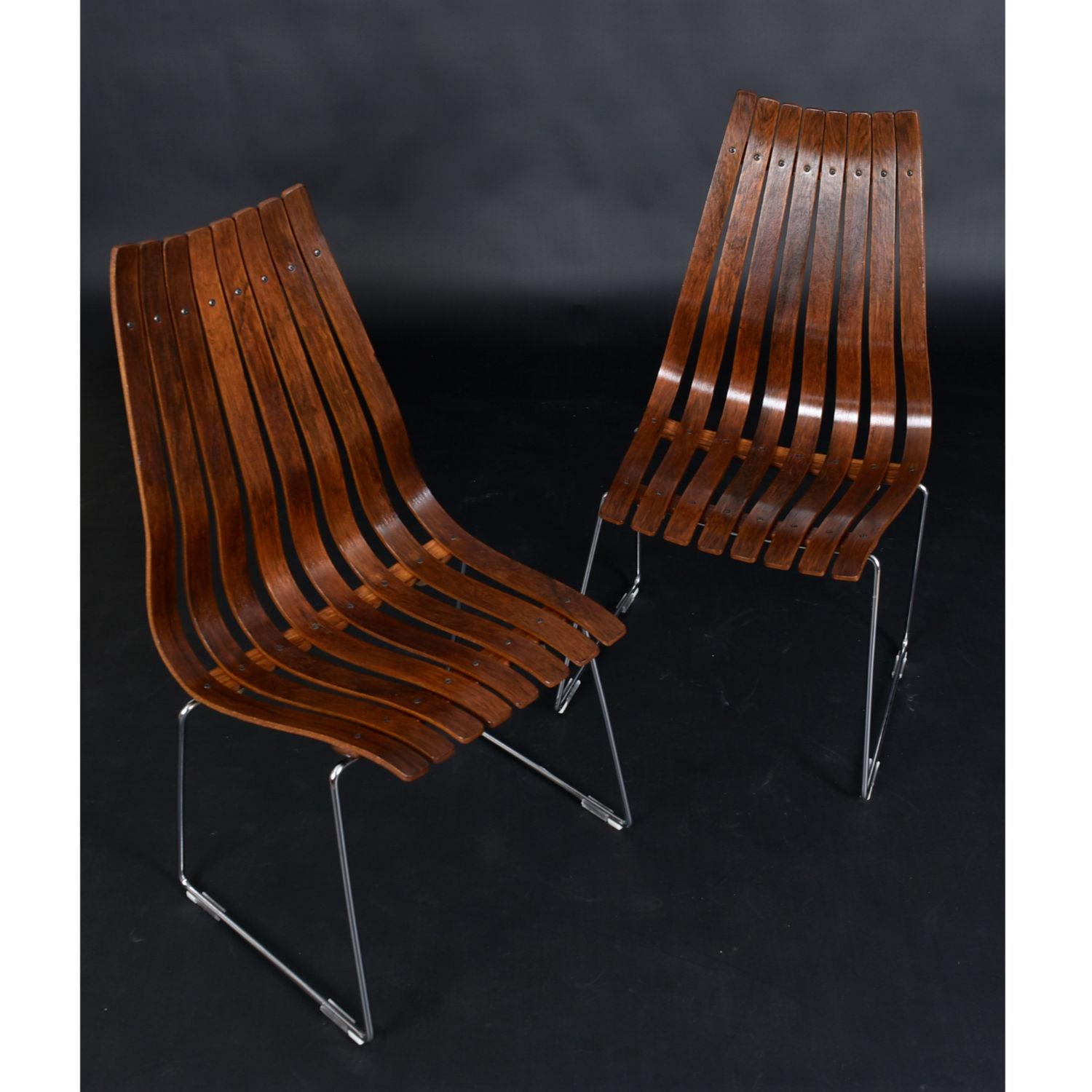 Rosewood slat back Hans Brattrud for Hove Mobler dining chairs. The chairs are sold as a pair. Designed in the late 1950s, this impeccable design has withstood the test of time. Crafted from an array of ergonomically contoured rosewood slats. These