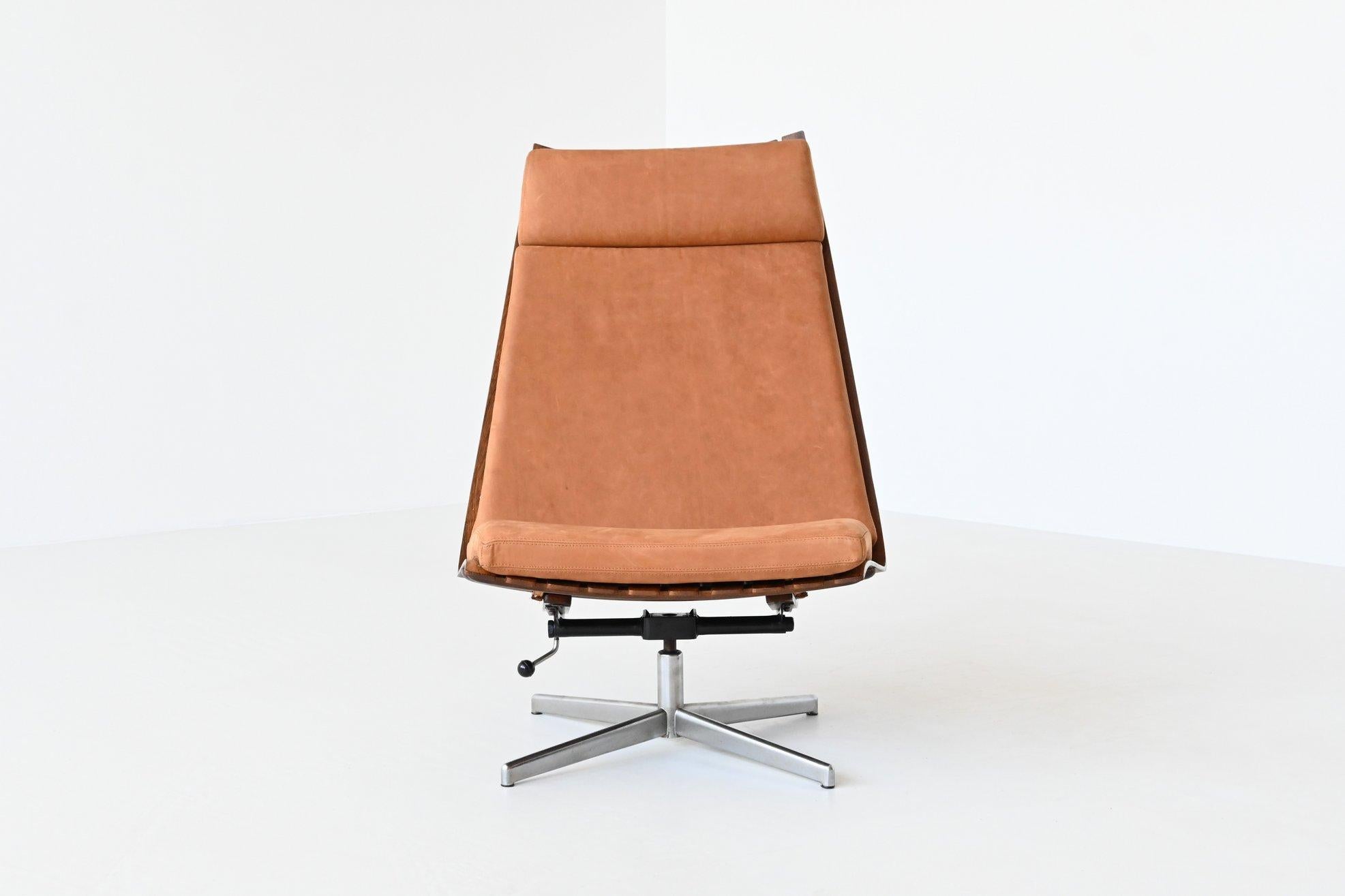 Fantastic sculptural high back swivel lounge chair designed by Hans Brattrud for Hove Mobler, Norway 1957. This amazing lounge chair is completely restored and a leather expert created a fitting, new cushion and headrest in a high quality, natural