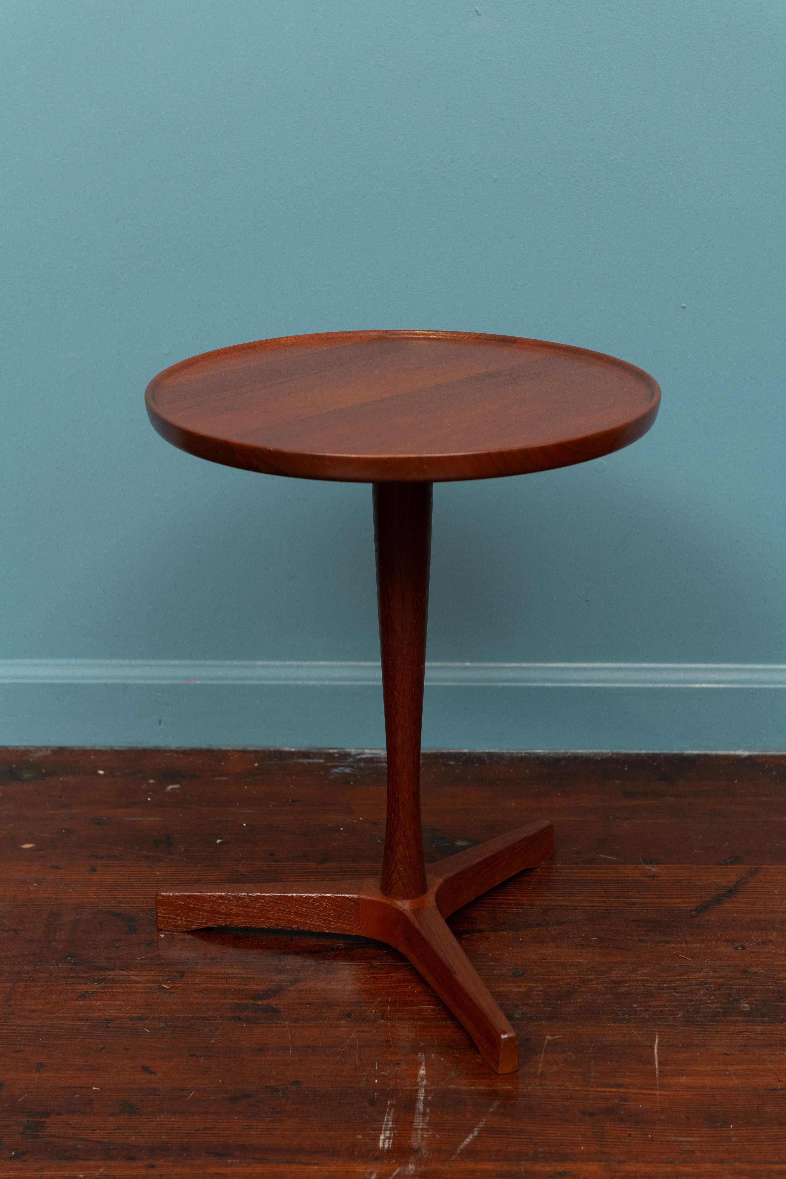 Hans C. Andersen design teak side table for Artek, Denmark. Sculpted edge dish top with a tapering pedestal and tripod base. Made from solid teak and newly refinished, stamped.