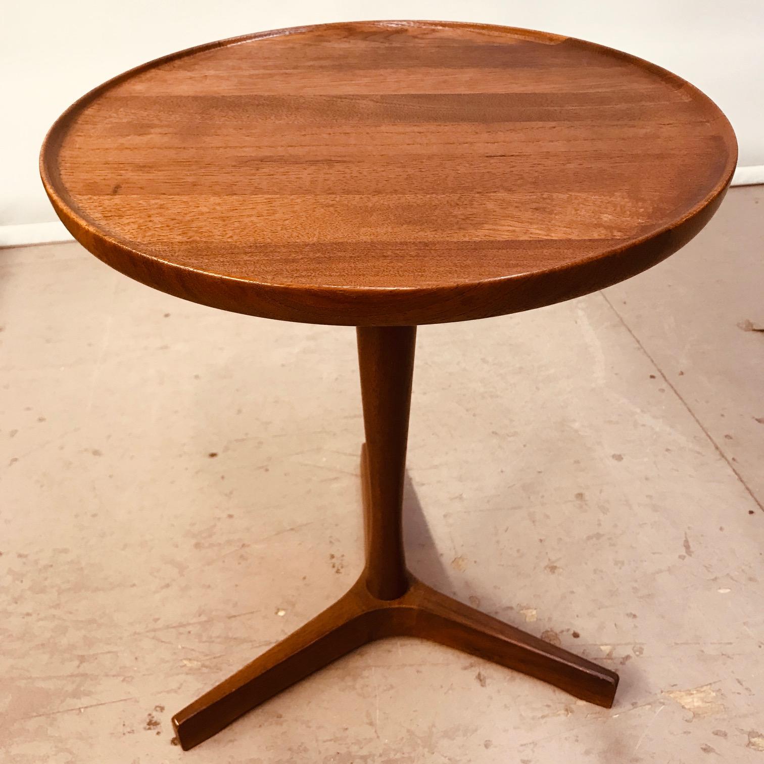 This small circular table expresses eloquently the simplicity of design and quality of execution of Danish furniture from the midcentury. The gently dished circular top, tapering pedestal and tripod stand all have a harmony of design and function.