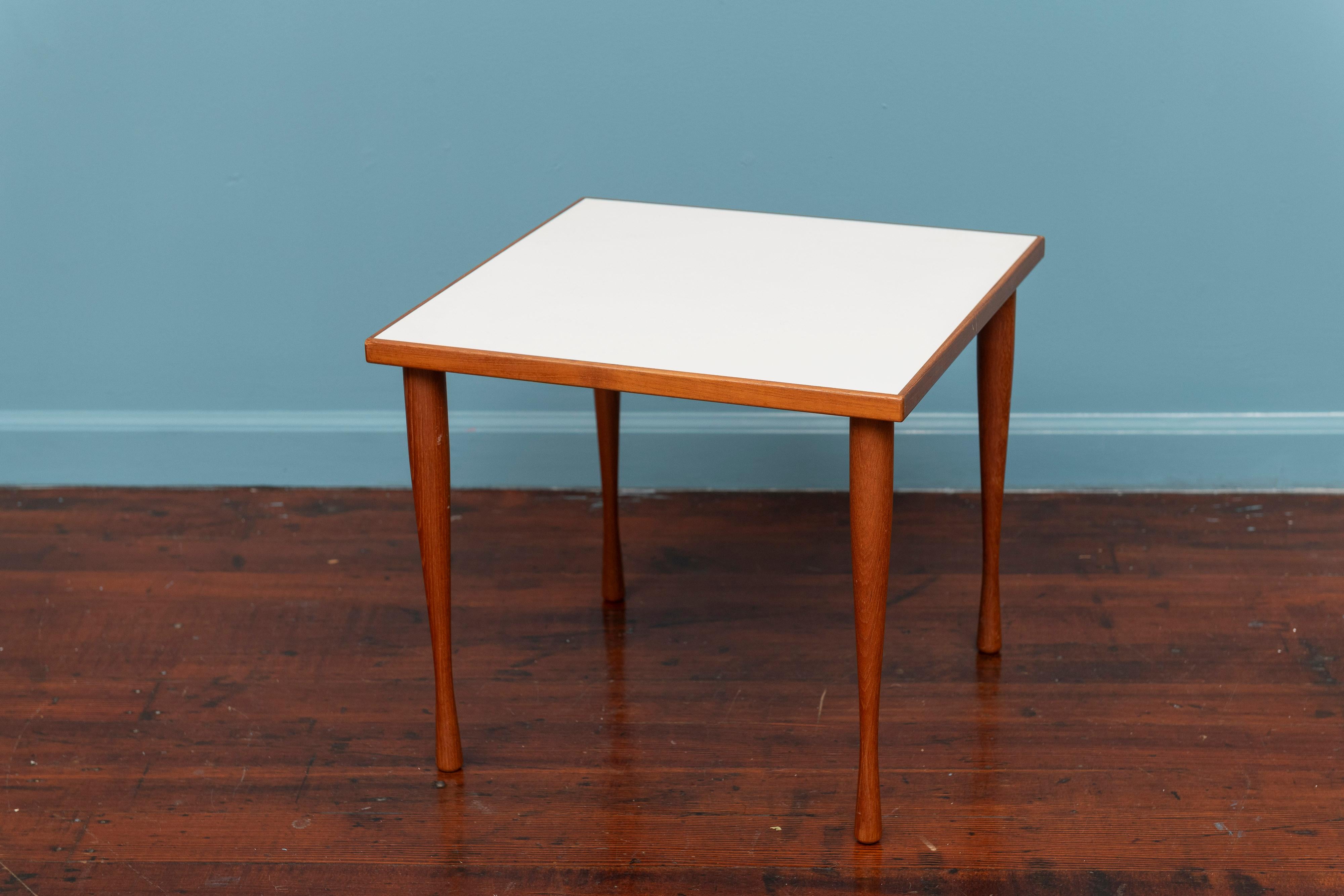 Hans C. Andersen design square end table. Made from teak and a white laminate top with tapering shaped detachable legs. In very good original condition, labeled.