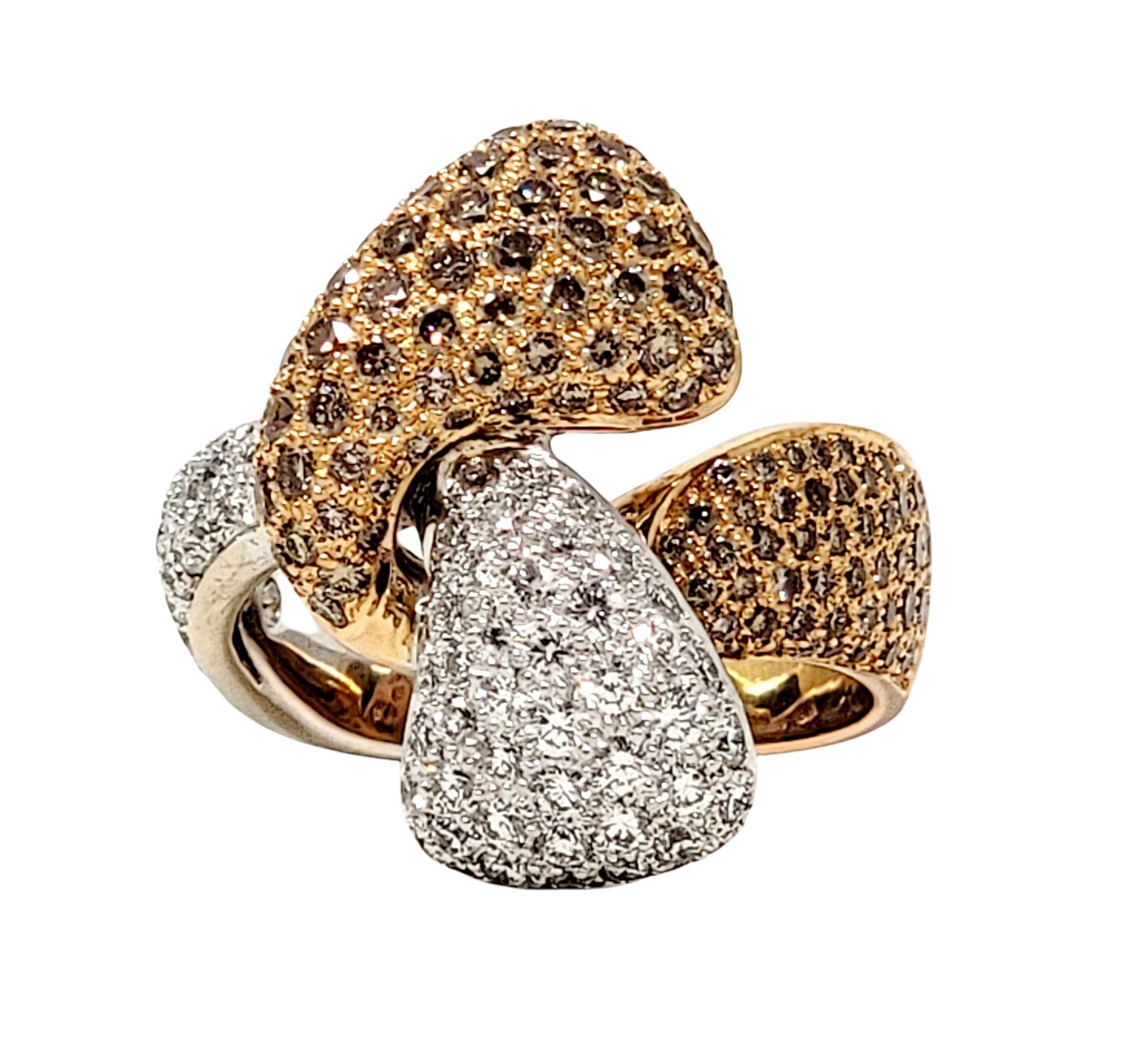 Ring size: 7.75

This absolutely stunning Hans D. Kreiger cocktail ring features a gorgeous combination of fancy brown and white pave diamonds in a contemporary twisted bypass design. 2.01 carats of natural diamonds sparkle beautifully and make this