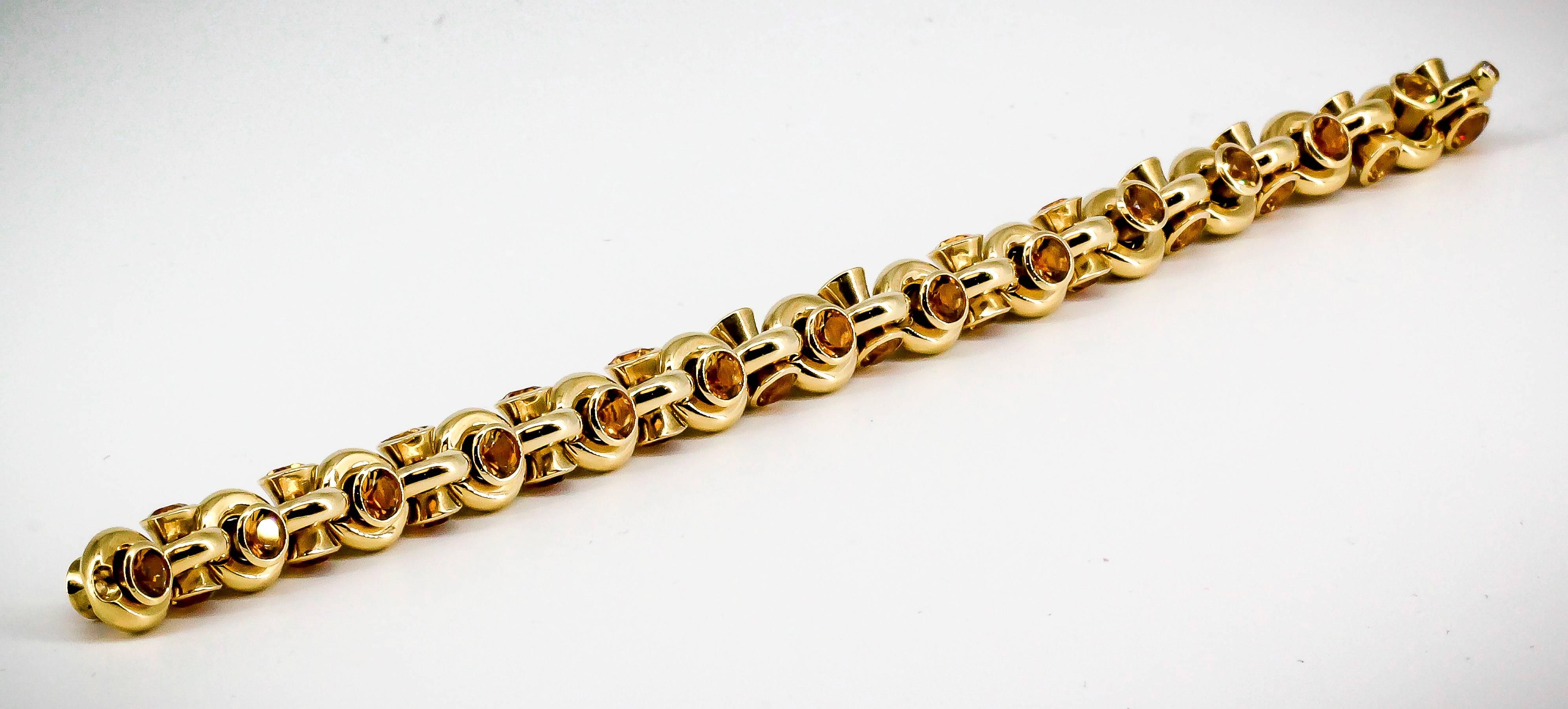 Intricate citrine and yellow 18K gold link bracelet by Hans D. Krieger. It features a rather unusual design, with each link housing a double sided cylinder with citrines on both ends. The clasp features a small diamond and is very well hidden.  A